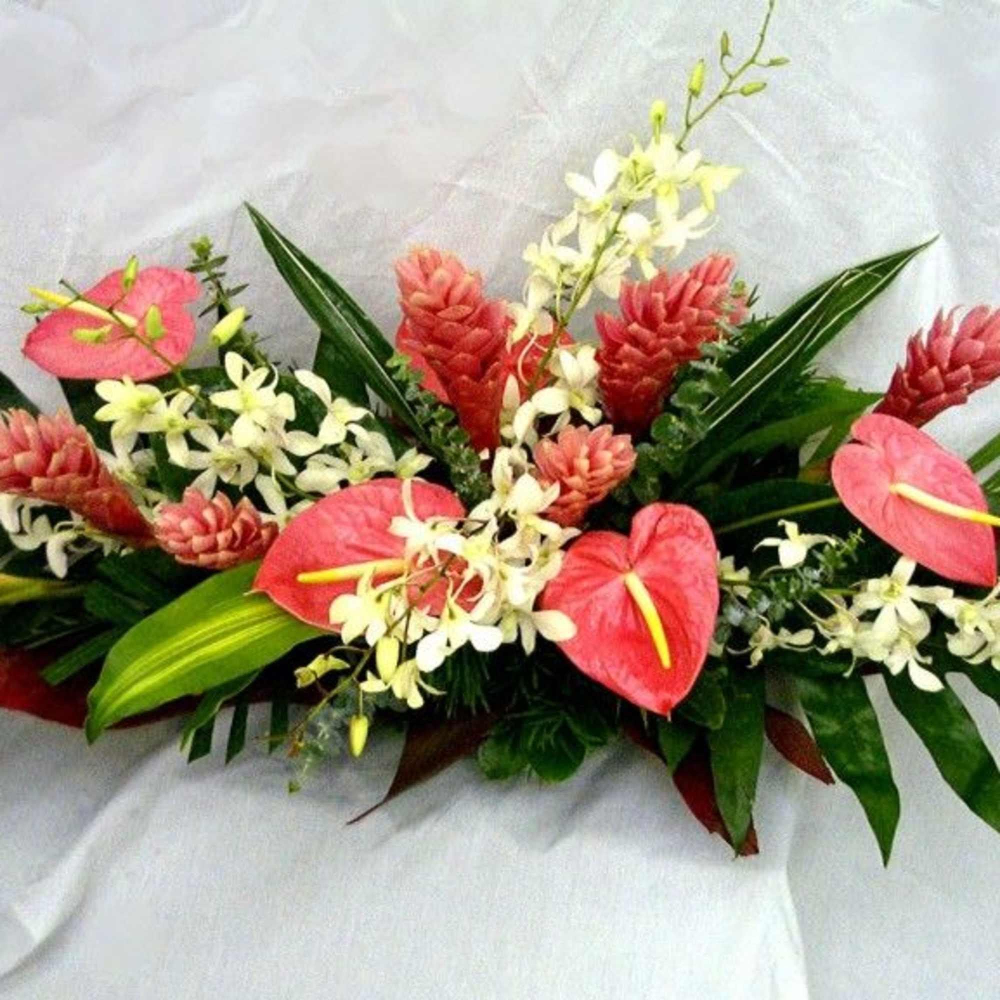 One  mixed tropical blooms and exotic foliage 