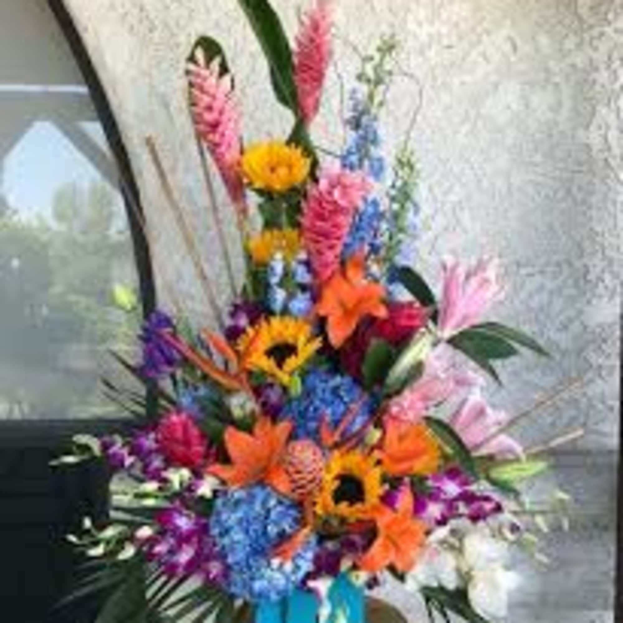 One  mixed tropical blooms and exotic foliage 