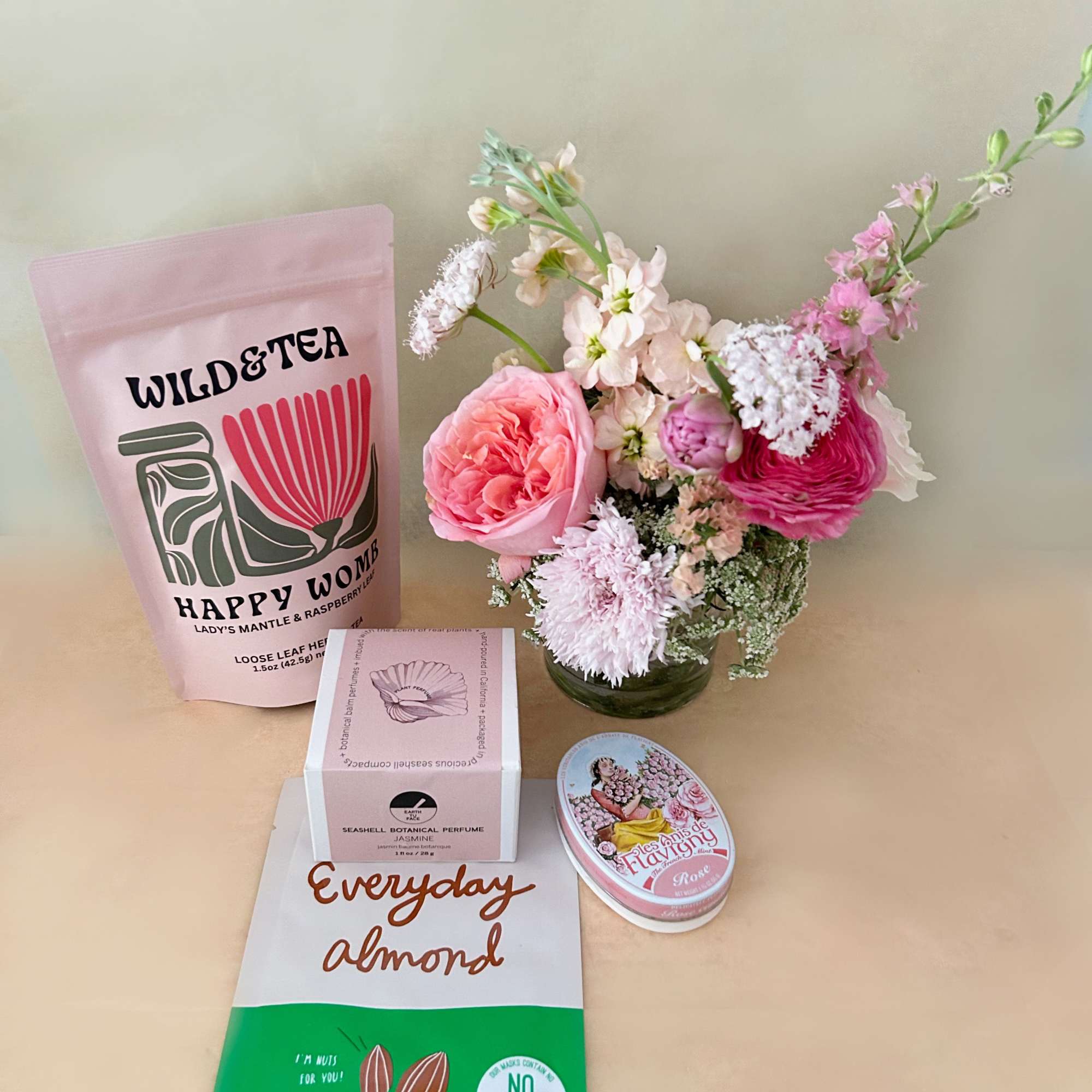 A wellness basket in the pretty colors of pink, white and green