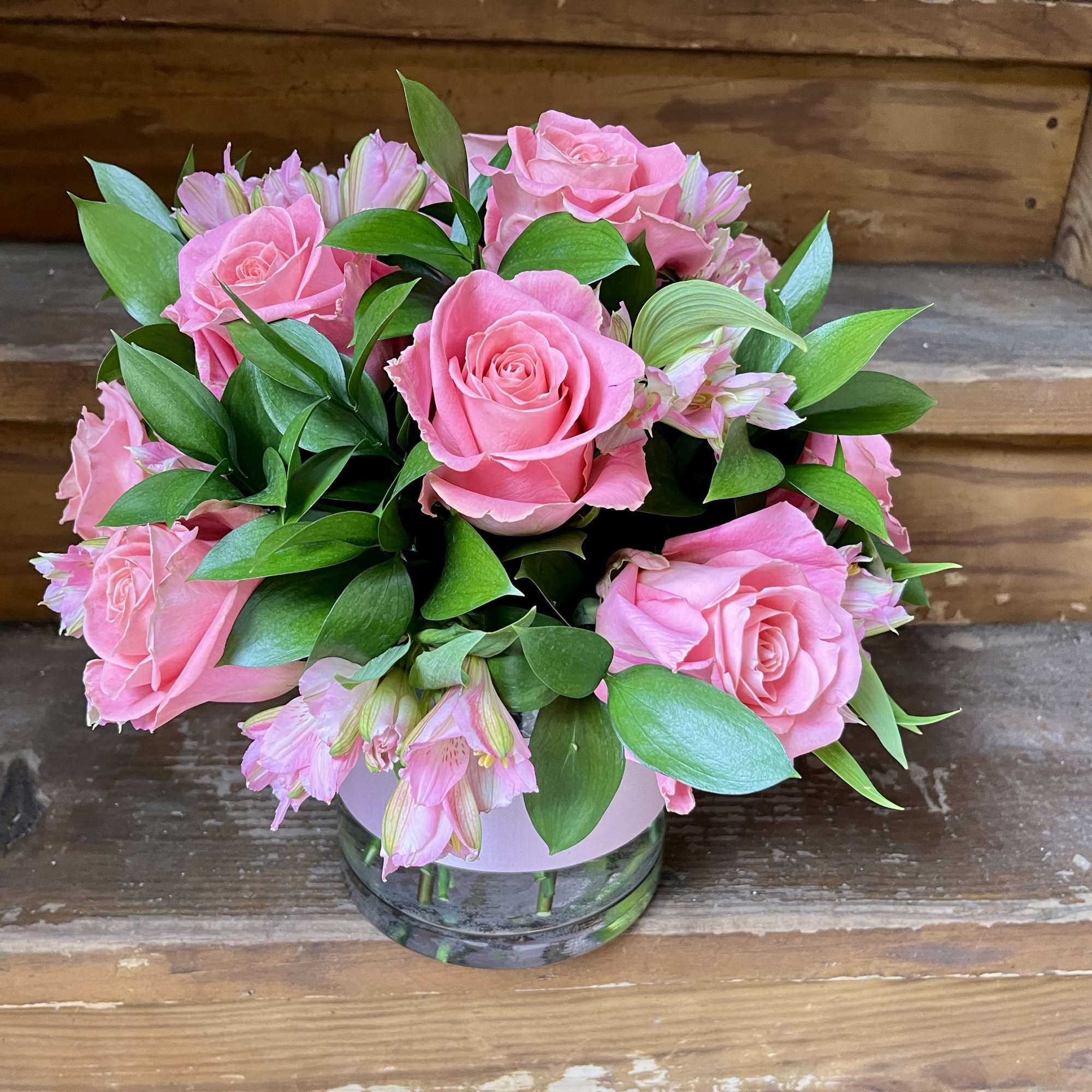 Pink roses and pale pink alstroemeria in a glass vase