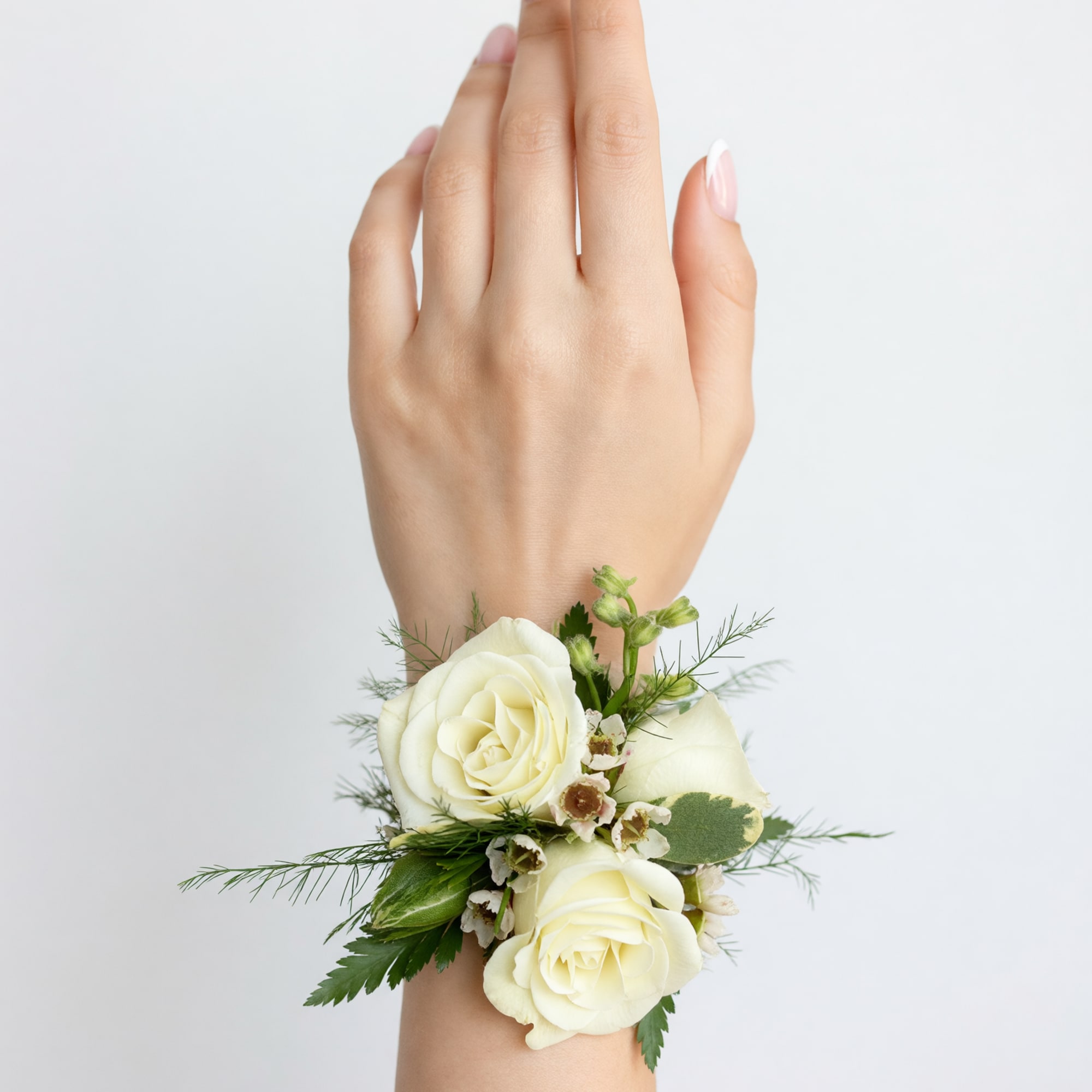 The Classic White Corsage consists primarily of white spray roses, with a