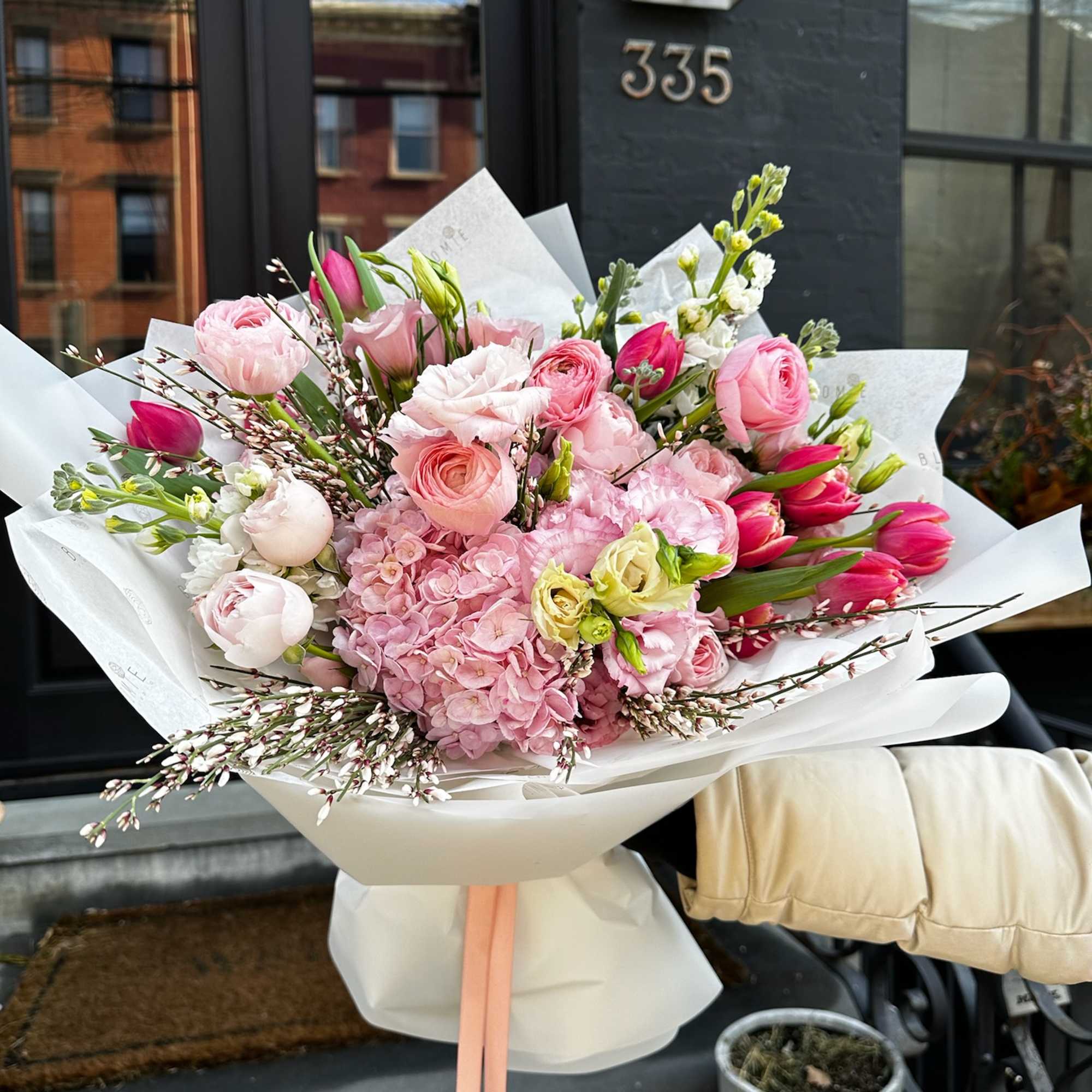 Pink and white mixed bouquet wrapped in white paper