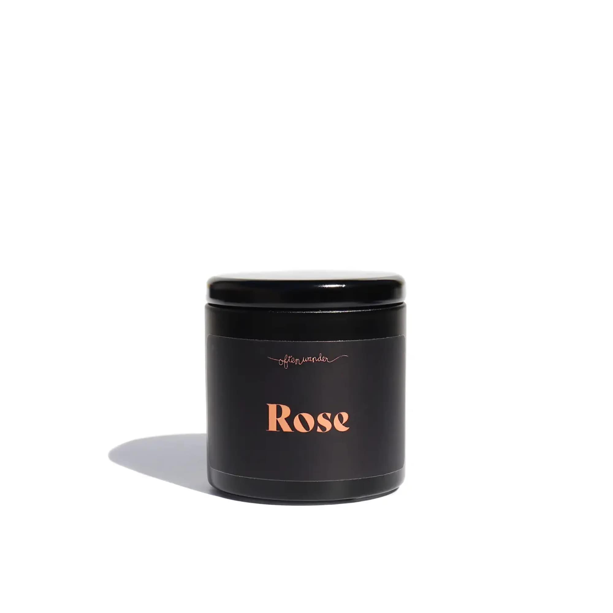 Black candle jar labeled Rose