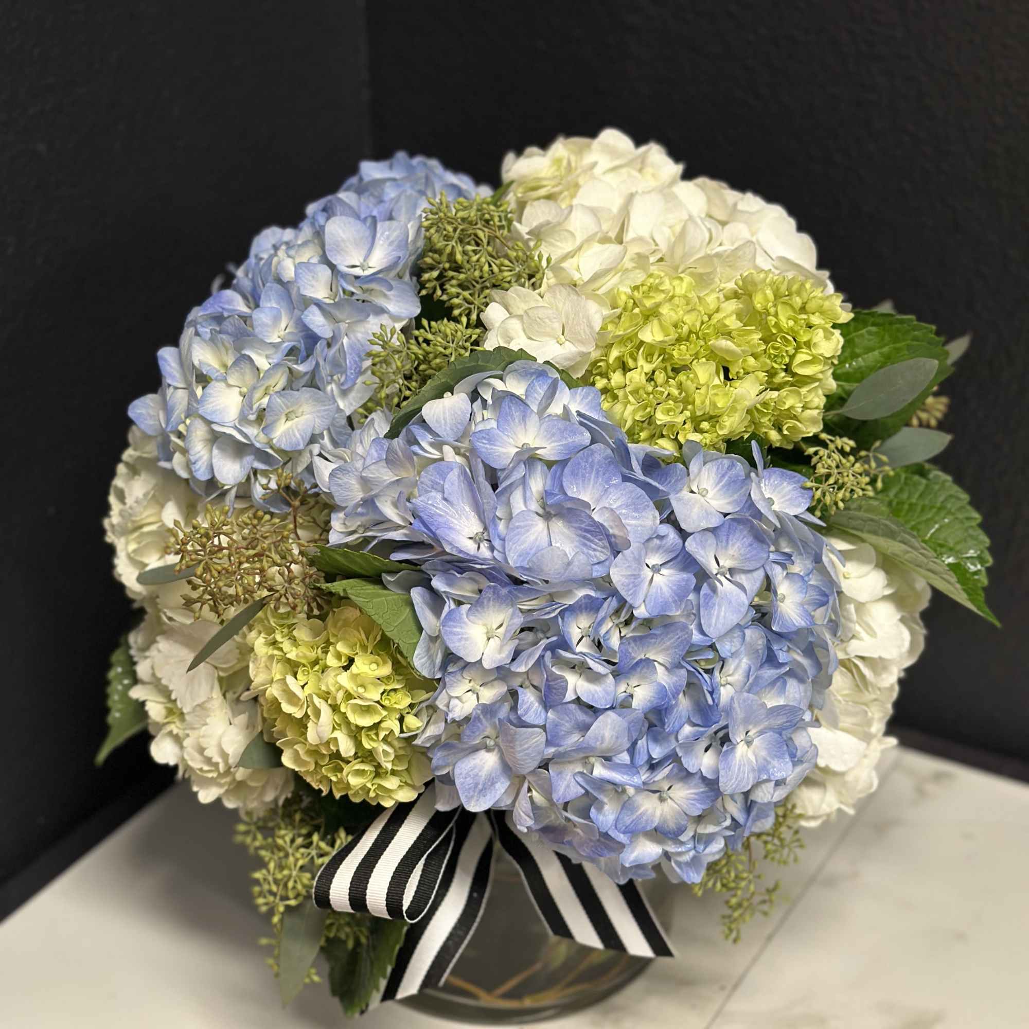 An elegant option for any occasion. Mixed hydrangea's en masse delivered in
