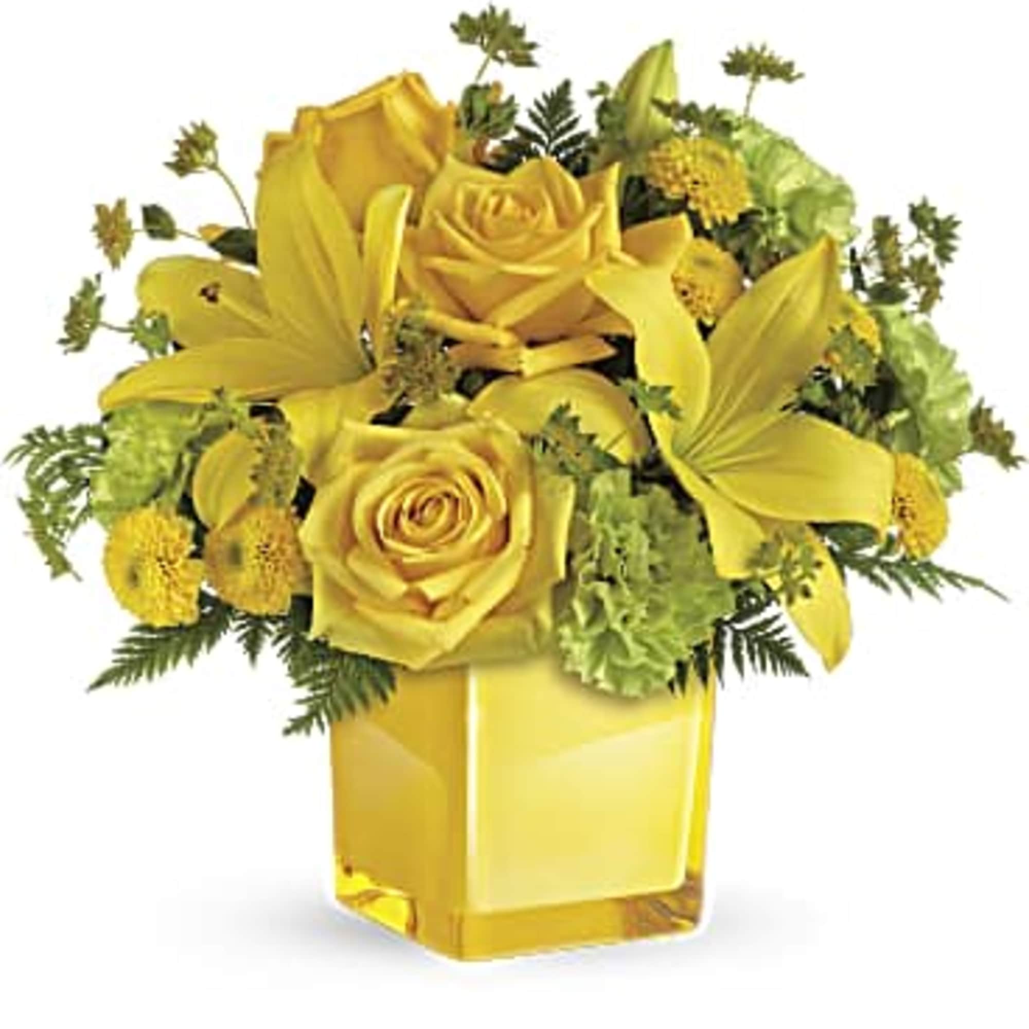 Yellow roses and lilies arranged in a square glass vase