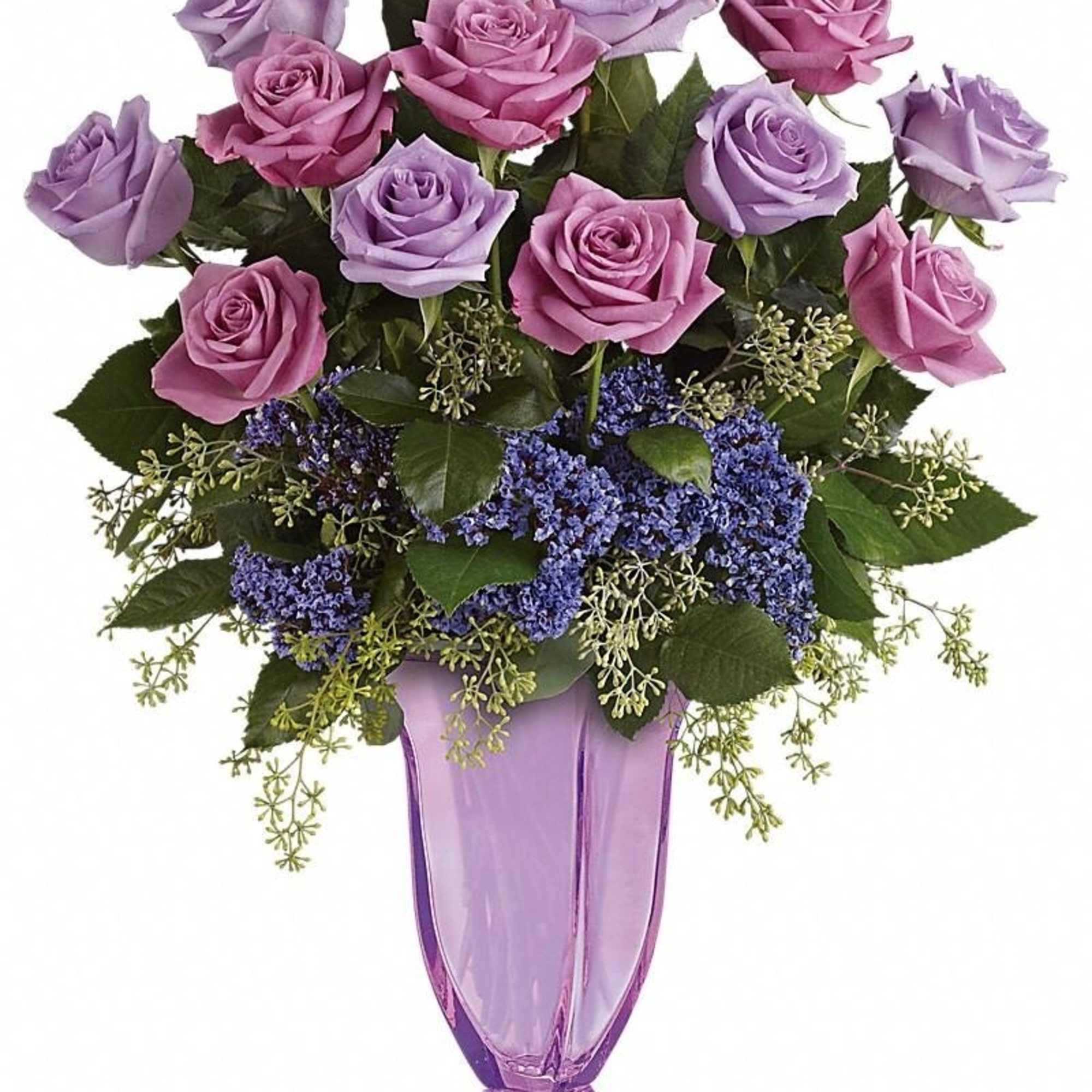 Tall arrangement of lavender and pink roses with purple filler flowers in a lavender glass vase
