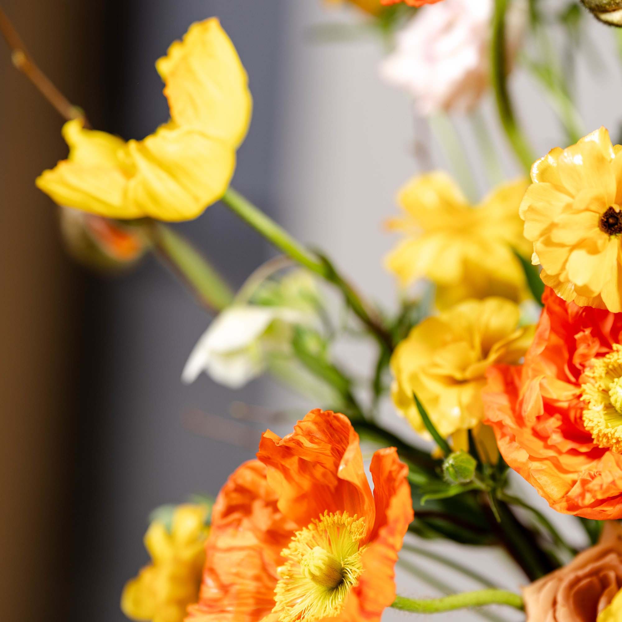 Orange and yellow poppy flowers in a bouquet
