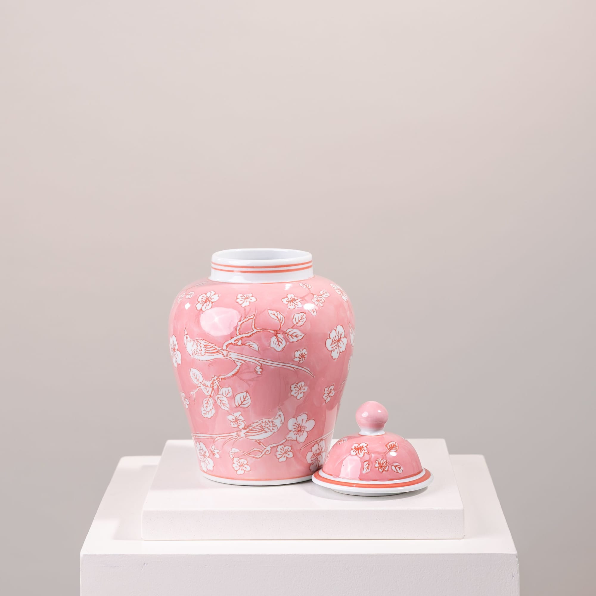 Pink ceramic jar with floral bird pattern and matching lid