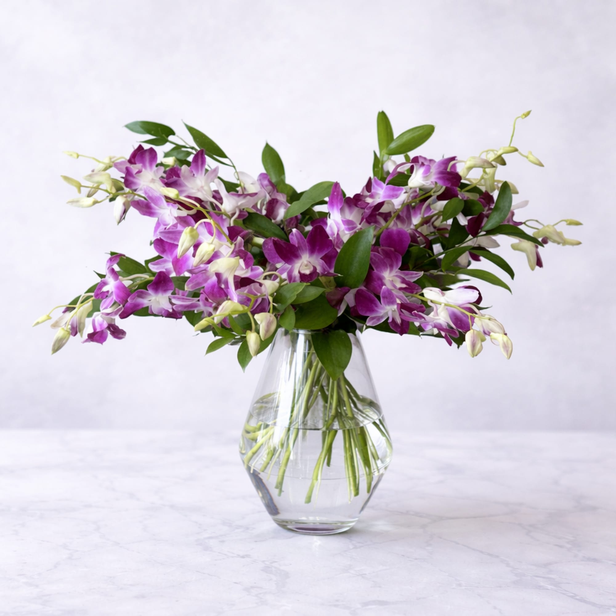 A dramatic spray of purple-and-white dendrobium orchids makes a memorable birthday bouquet