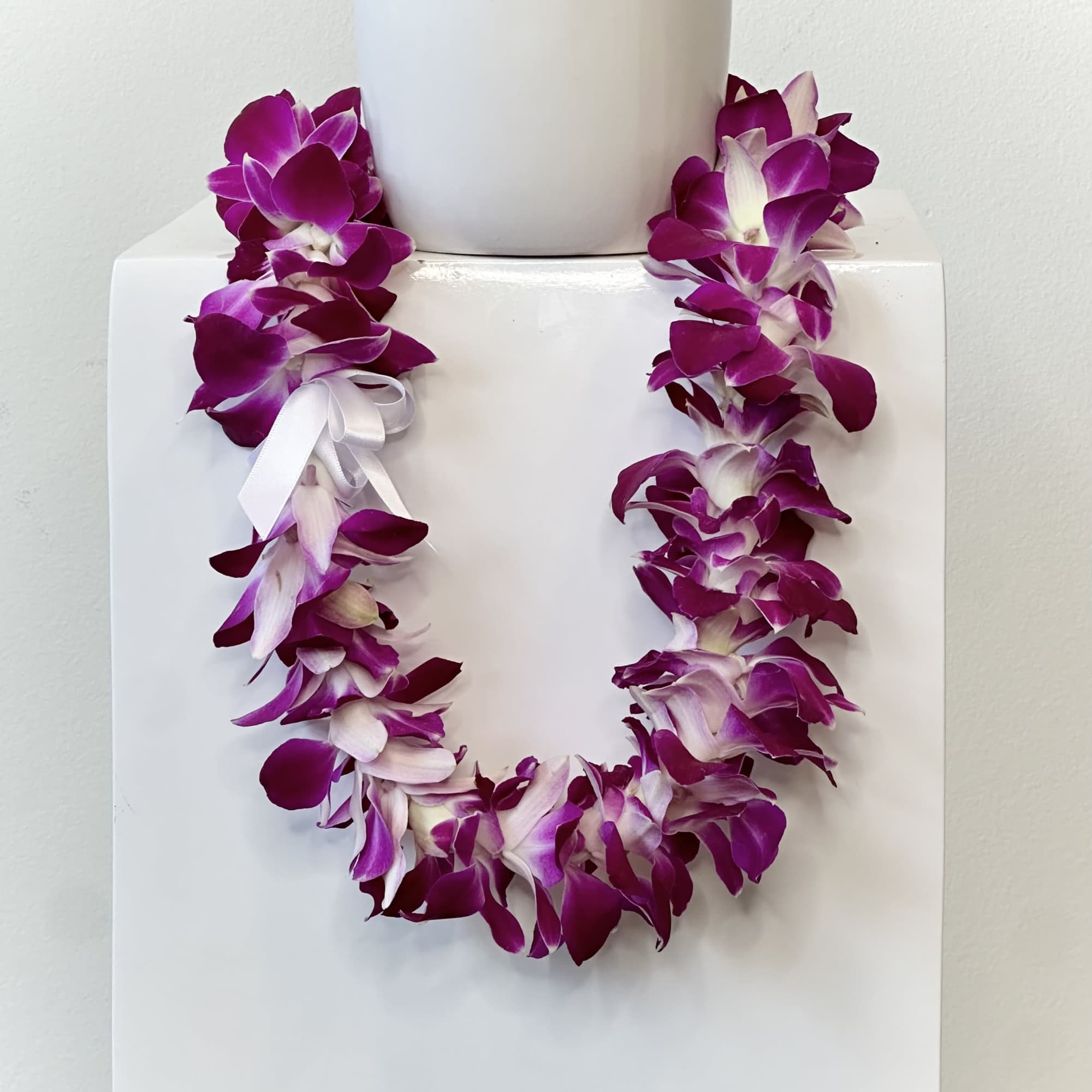 Celebrate a meaningful milestone with a beautifully crafted Orchid Lei, a timeless
