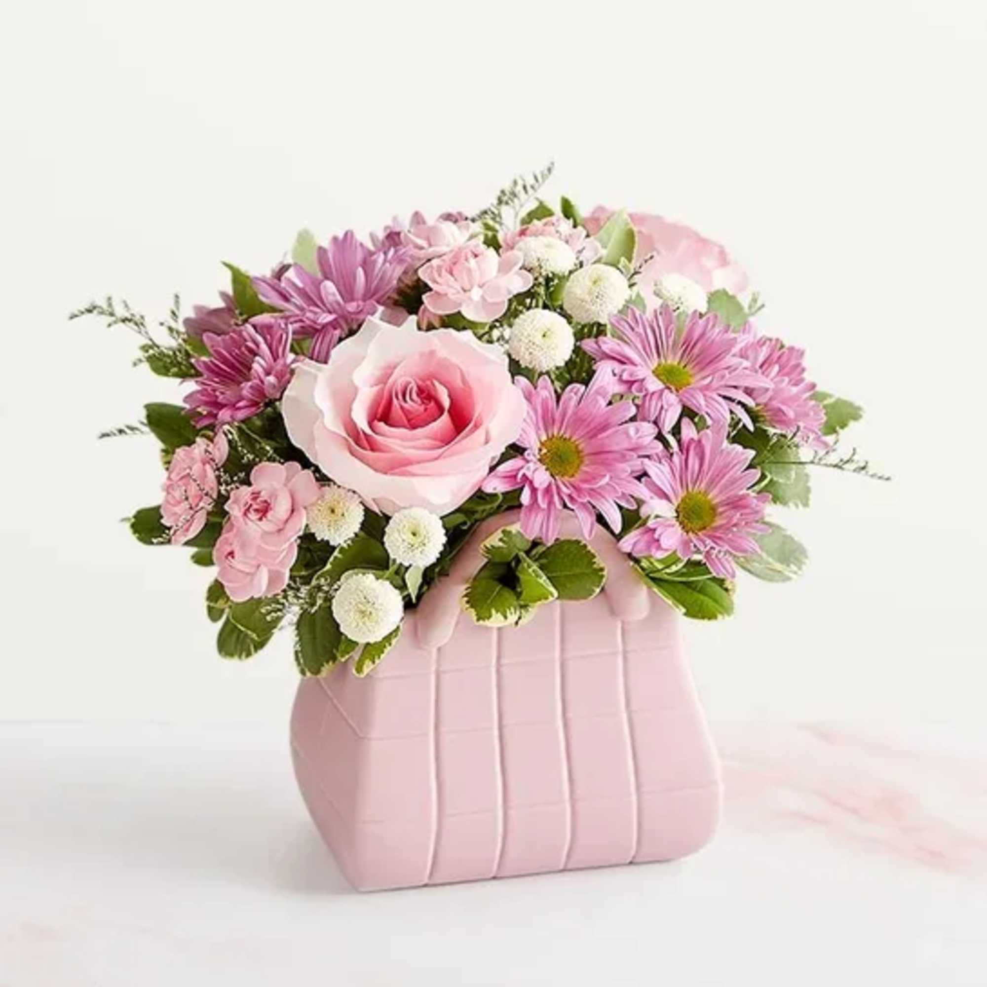 Pink rose and daisy bouquet in a blush pink vase