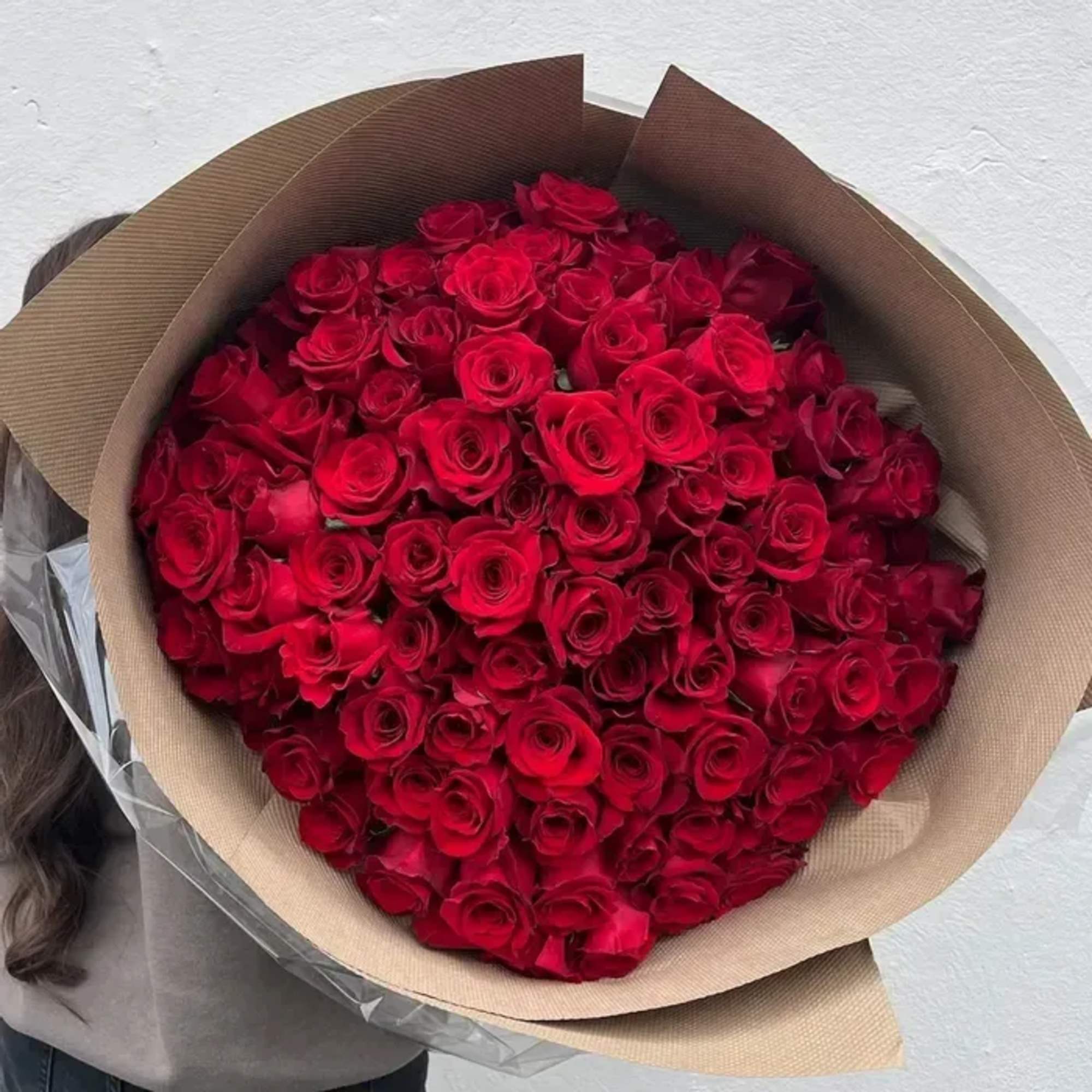 One hundred exquisite roses, hand-selected and wrapped with intention. A lavish expression