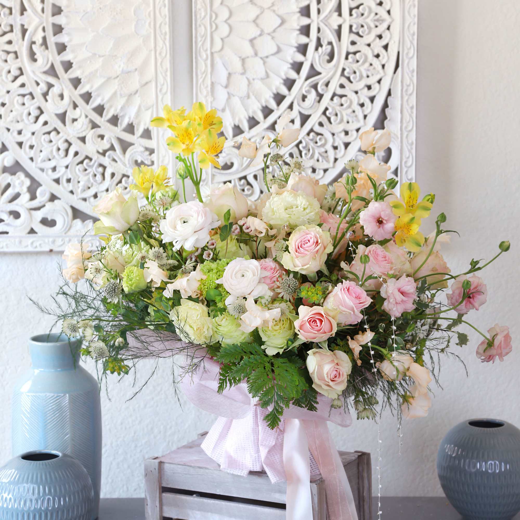 Pic shown as deluxe size. Features Blushes roses, ranunculus, sweet peas with