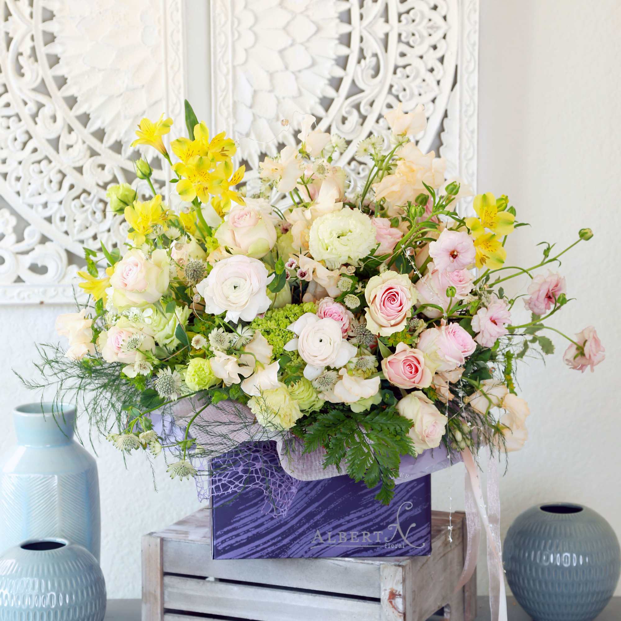 Pic shown as deluxe size. Features Blushes roses, ranunculus, sweet peas with