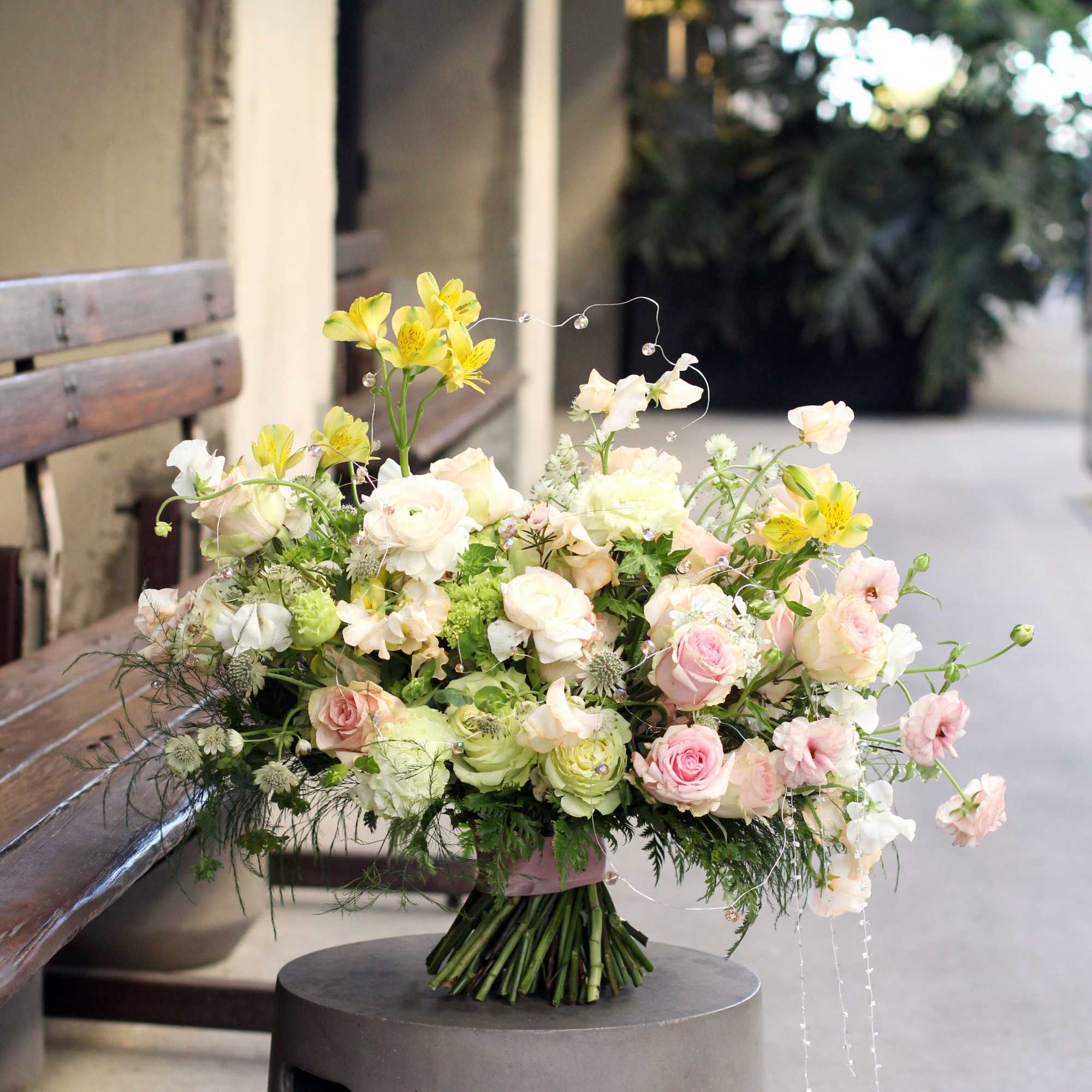 Pic shown as deluxe size. Features Blushes roses, ranunculus, sweet peas with