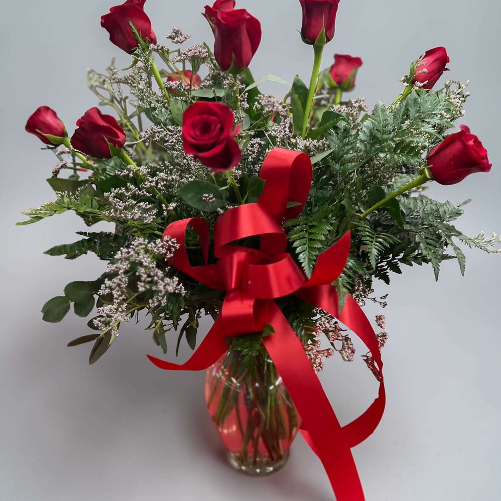 Deep, romantic red roses arranged in a light, hand-tied style make a