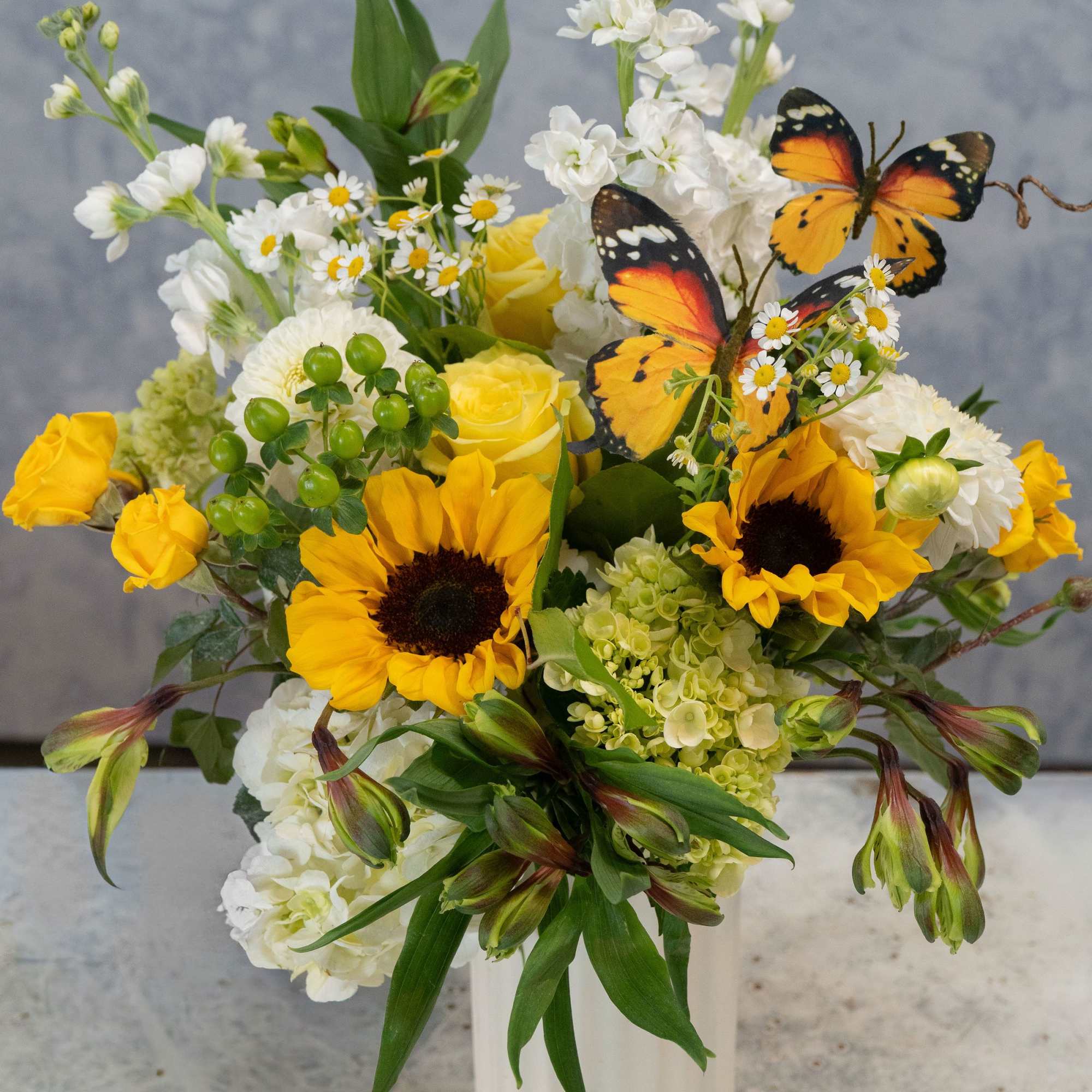 Sunflowers steal the show in this sunny flower arrangement, a cheerful birthday