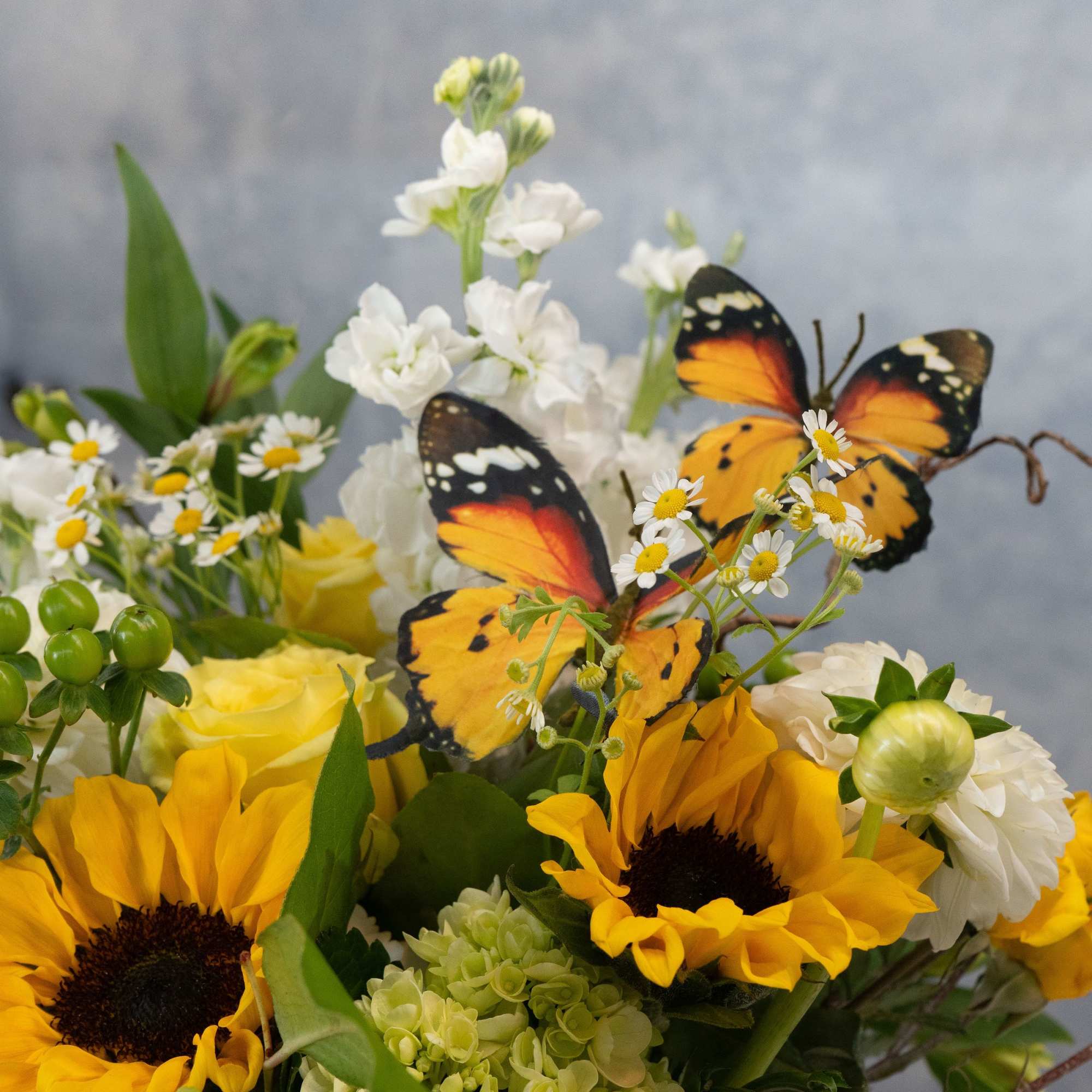 Sunflowers steal the show in this sunny flower arrangement, a cheerful birthday