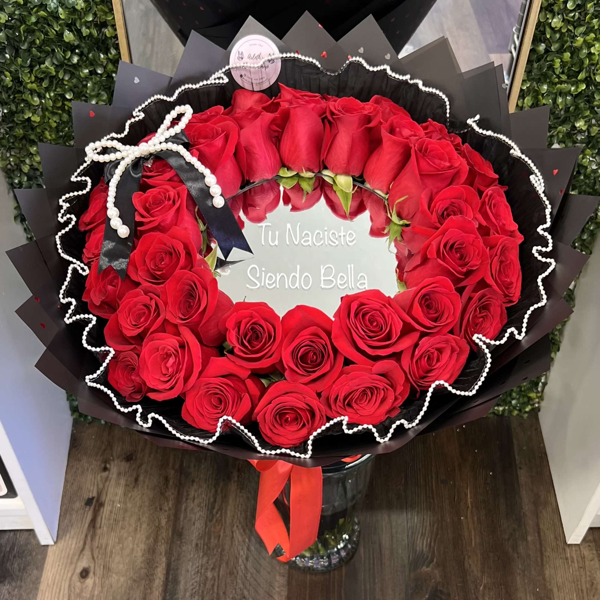 A stunning arrangement of red roses with a mirror, designed to reflect