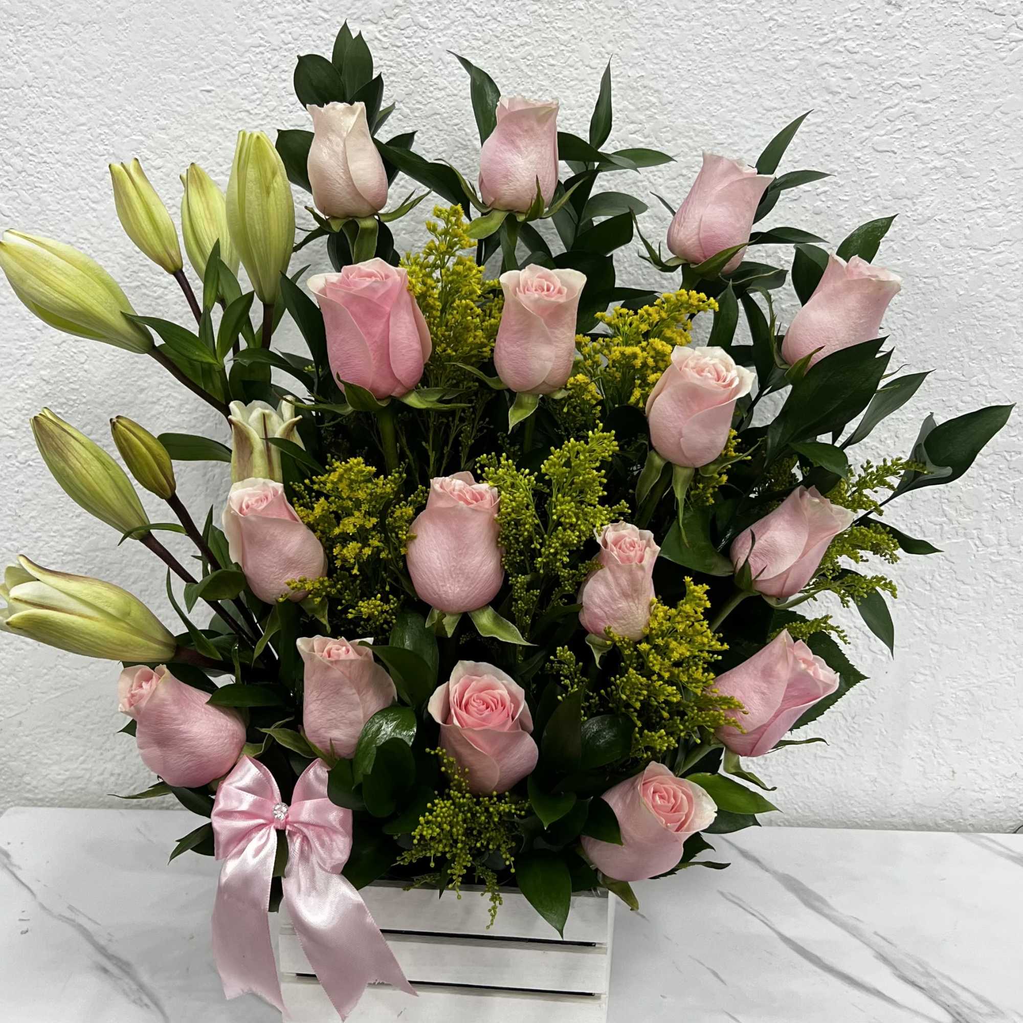 A delicate mix of pink roses and lilies, full of elegance, love
