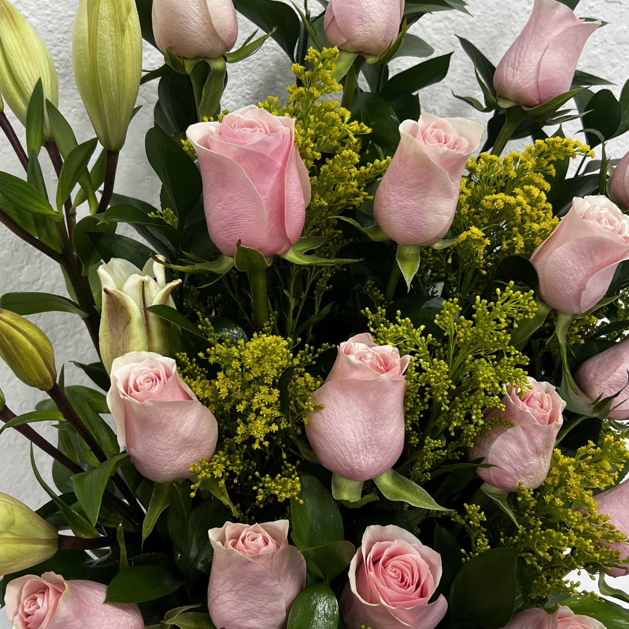 A delicate mix of pink roses and lilies, full of elegance, love