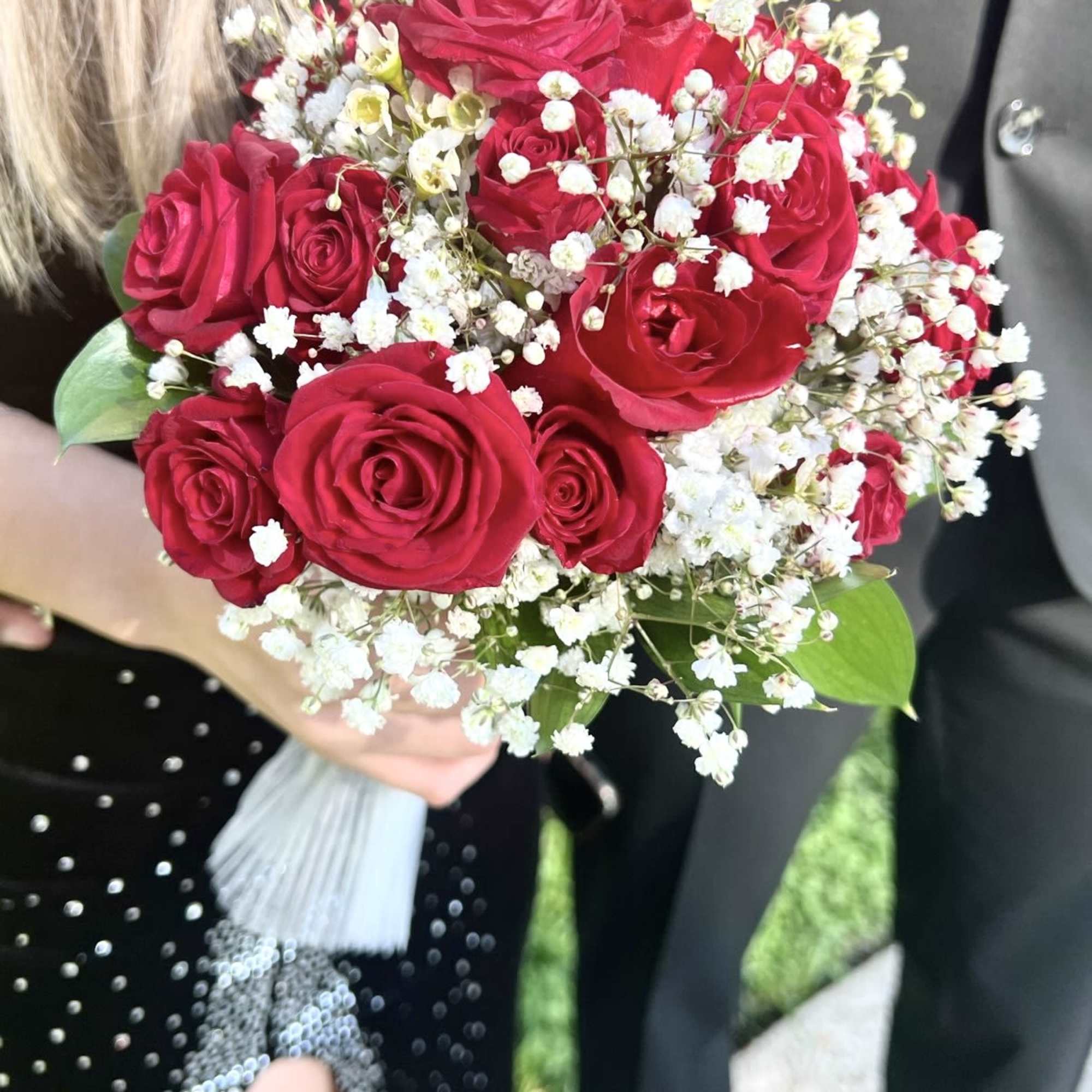 A set of  matching Boutonniere and Bouquet created with red roses