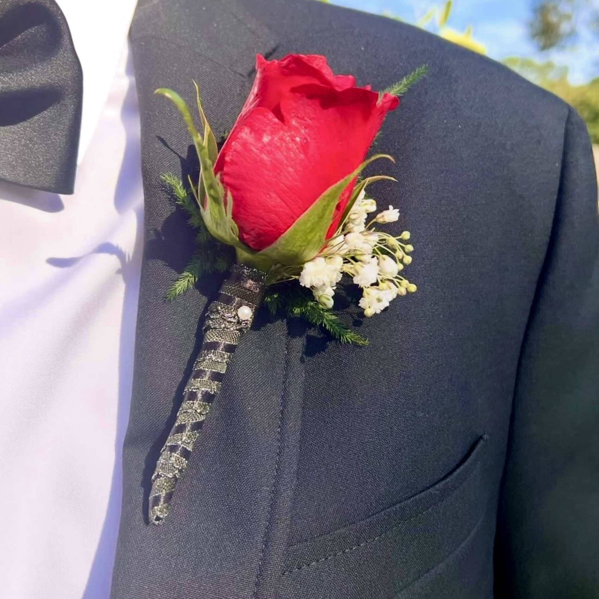 A set of  matching Boutonniere and Bouquet created with red roses