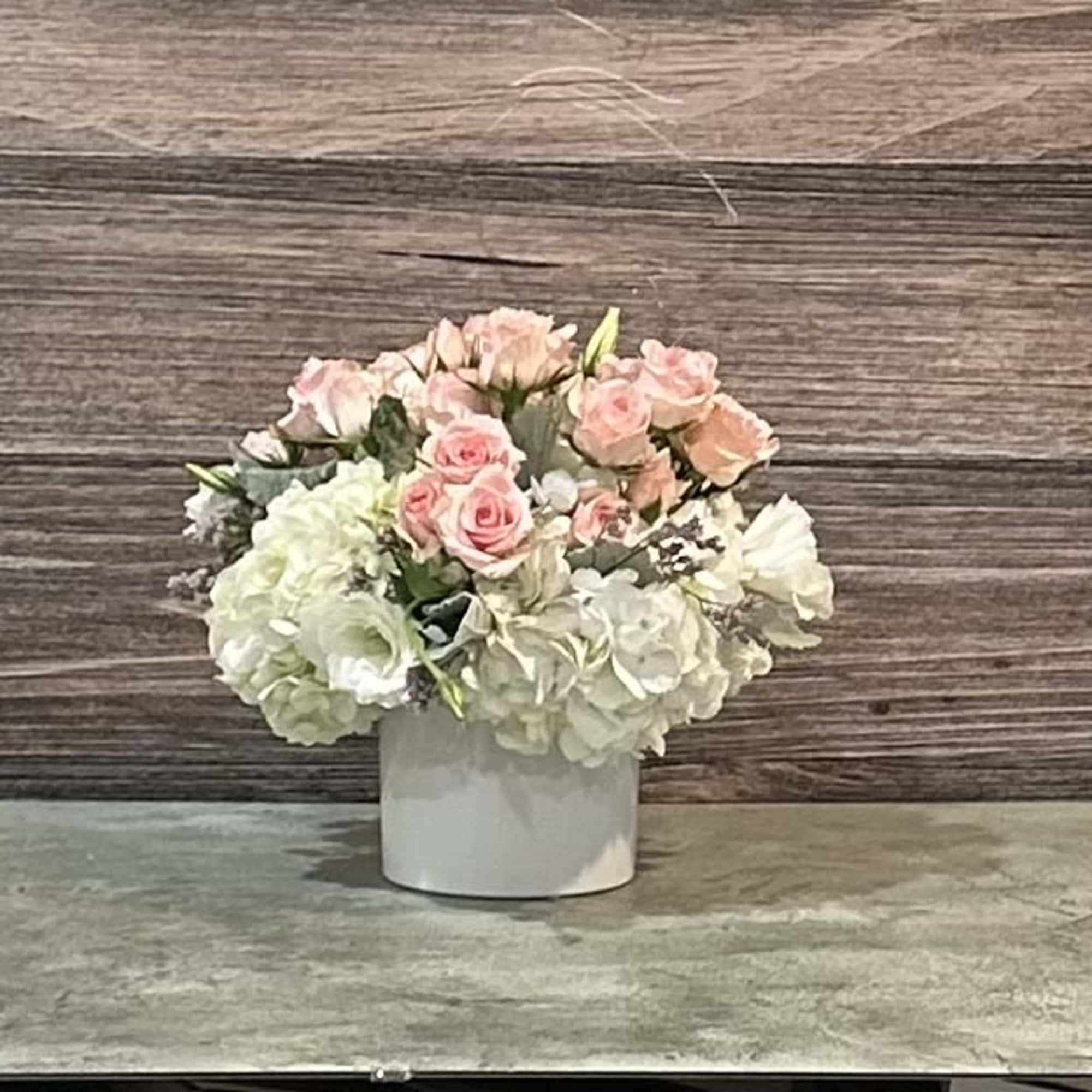 This angelic arrangement is as cute as it is pretty. Featuring the