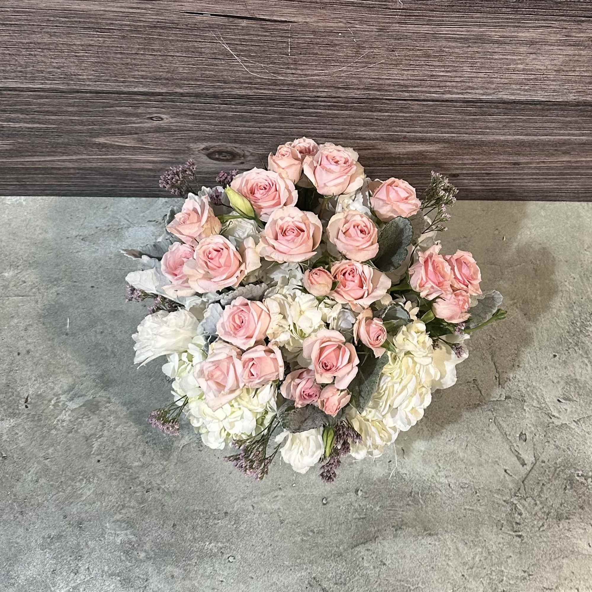 This angelic arrangement is as cute as it is pretty. Featuring the