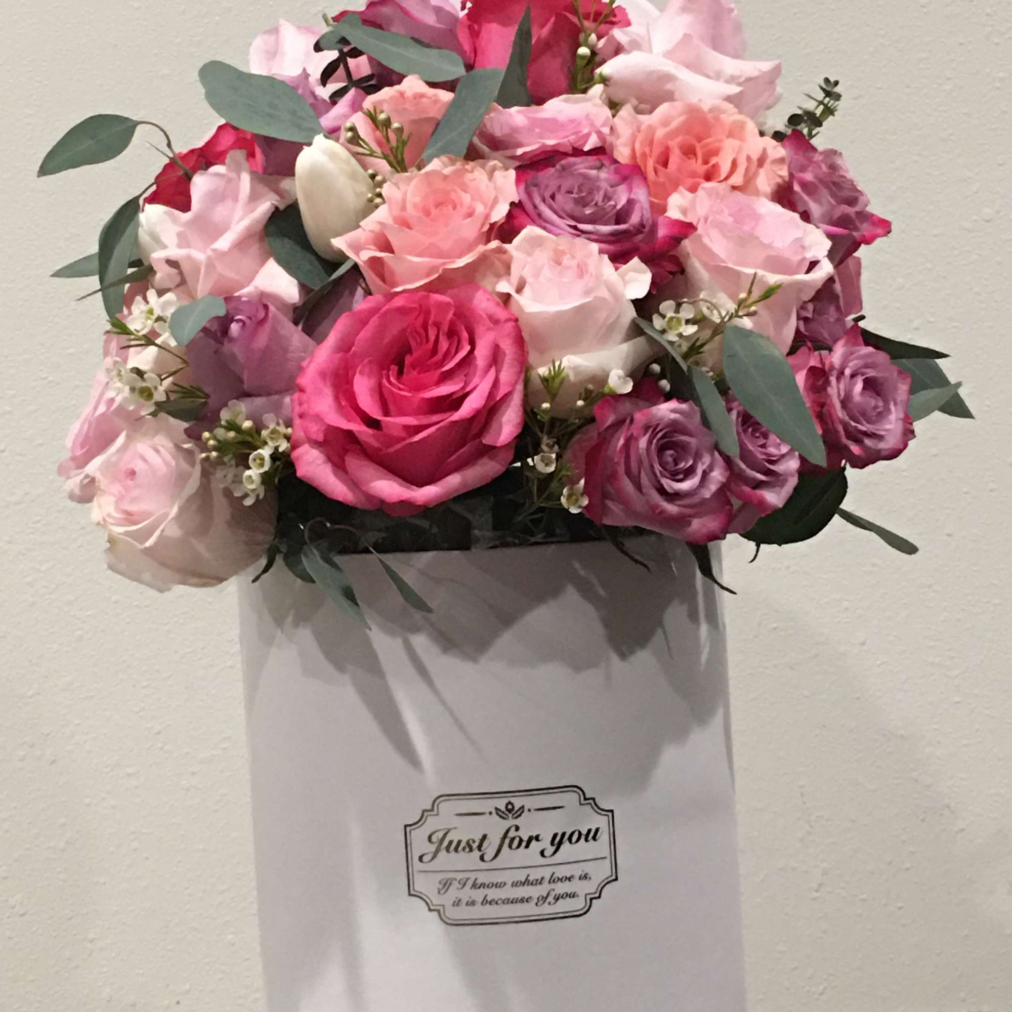 Pink and lavender rose bouquet in a white gift box