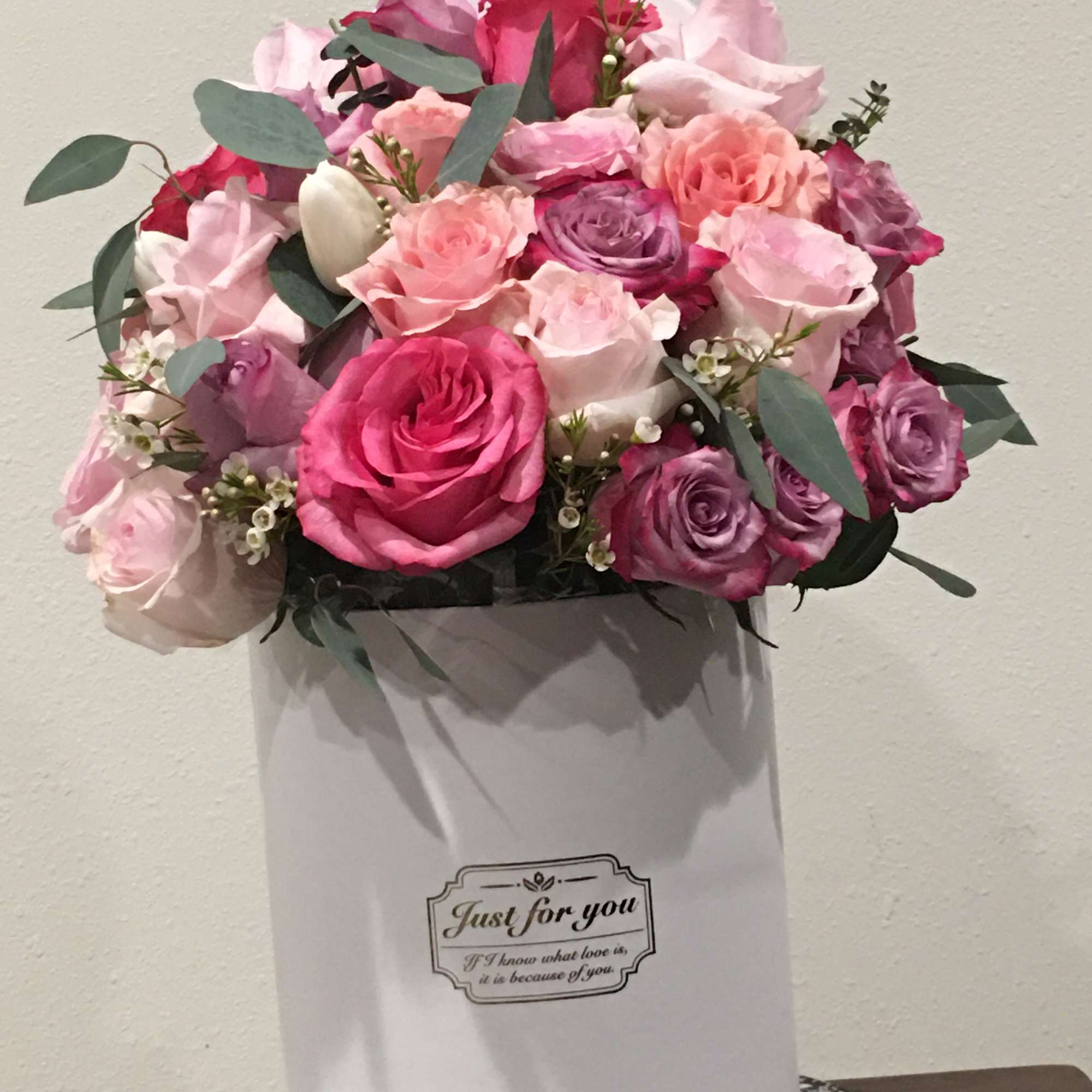 Pink and purple rose bouquet in a white gift box