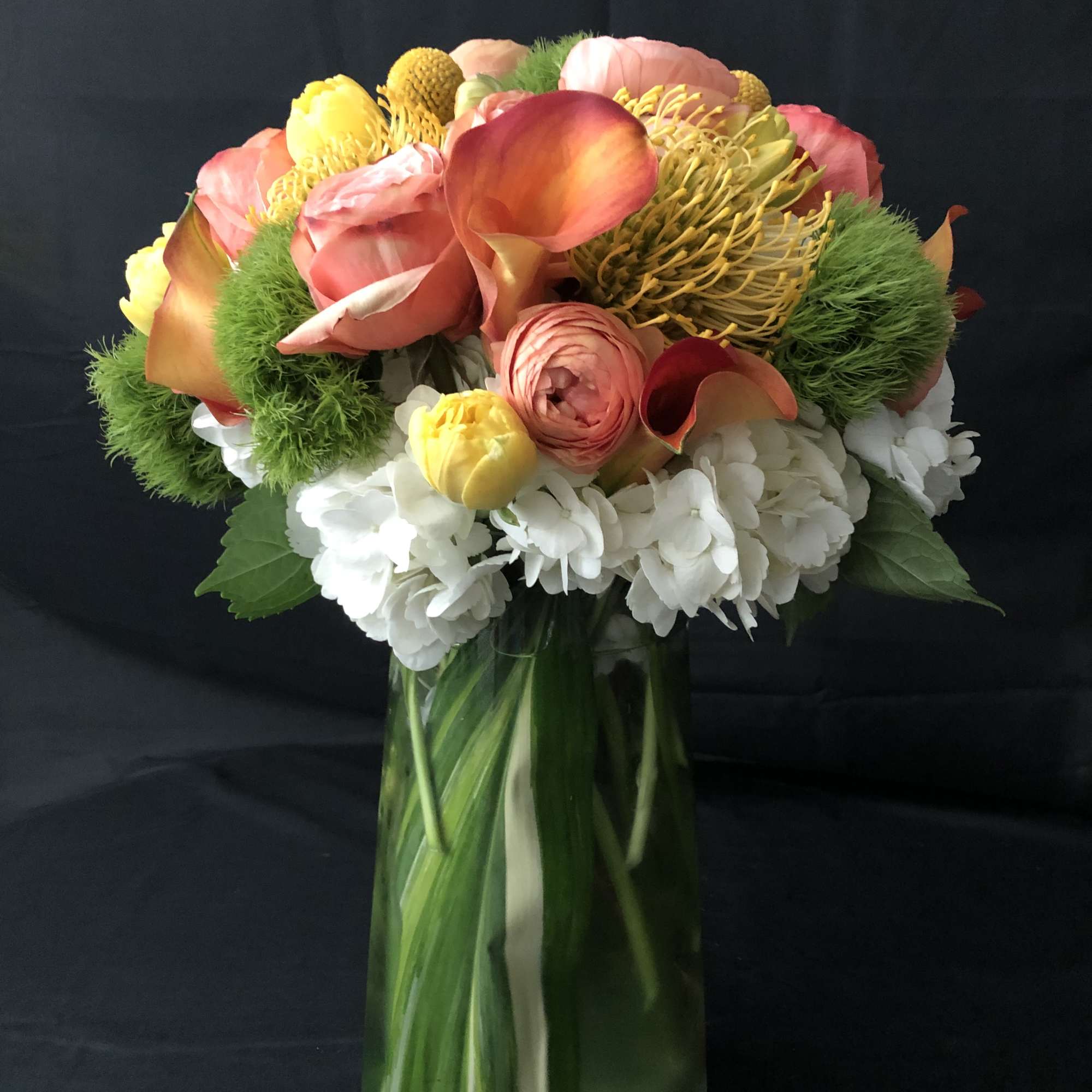 Colorful bouquet of tropical flowers in a glass vase