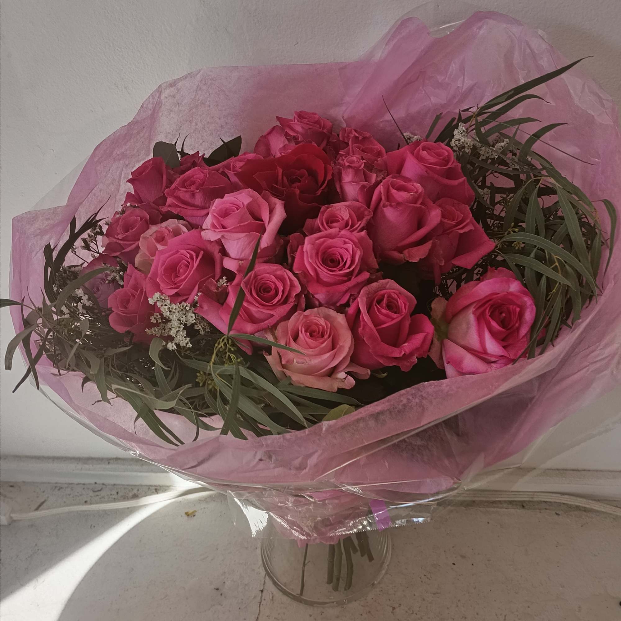 Bouquet of pink roses wrapped in pink paper