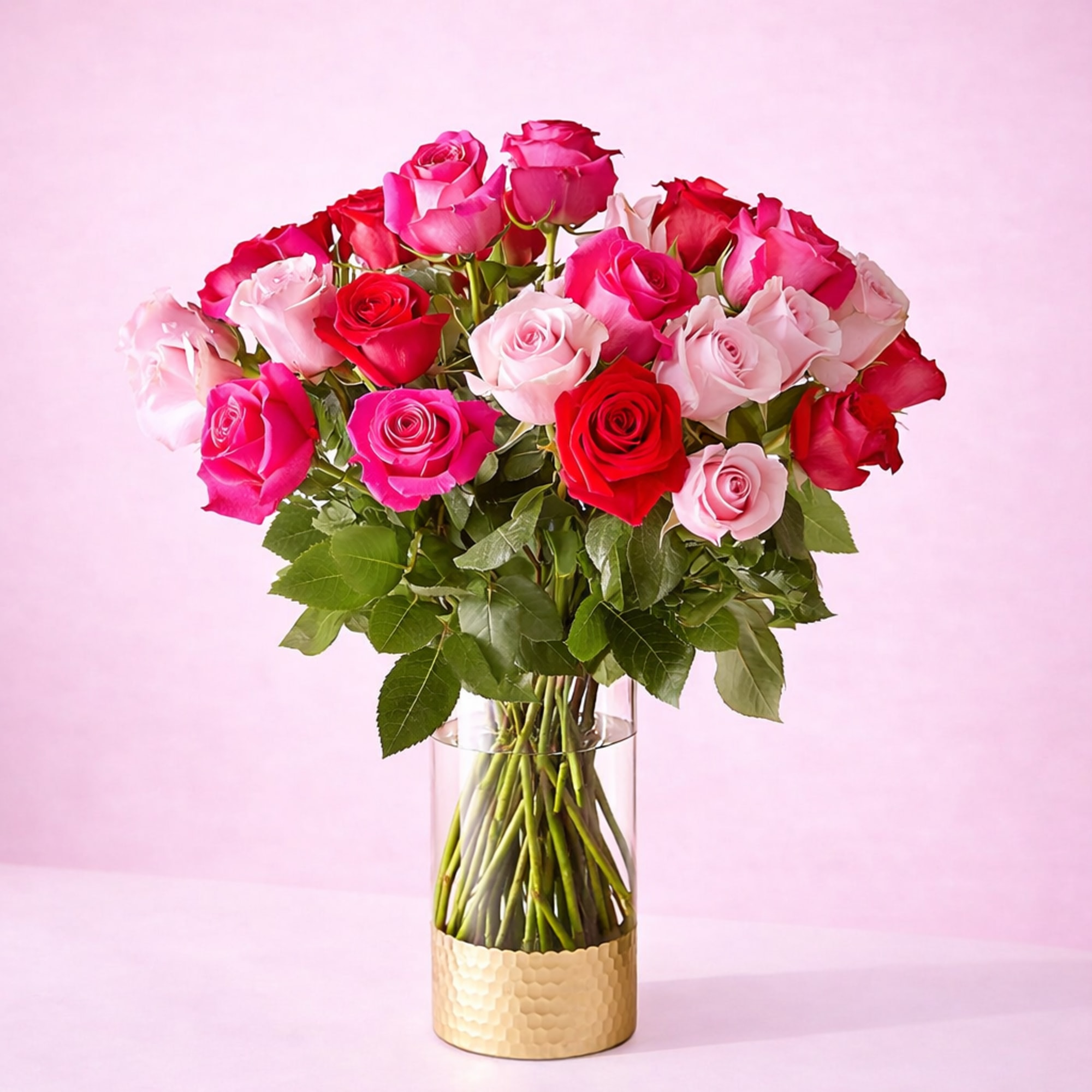English:
Premium long-stem rose arrangement in fuchsia, pink, and red tones, presented in