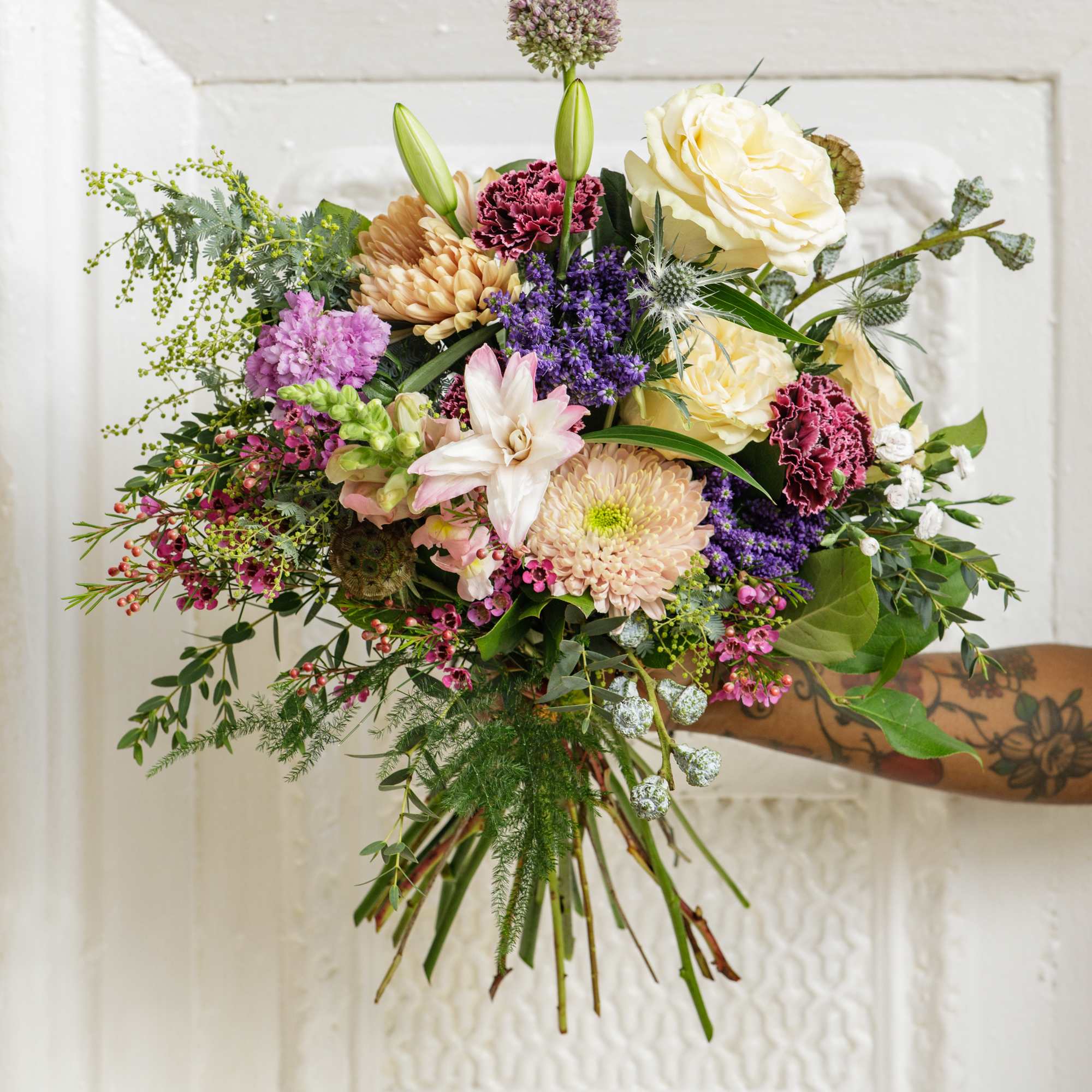 Gift them this lush hand-tied bouquet, created using a fresh mix of