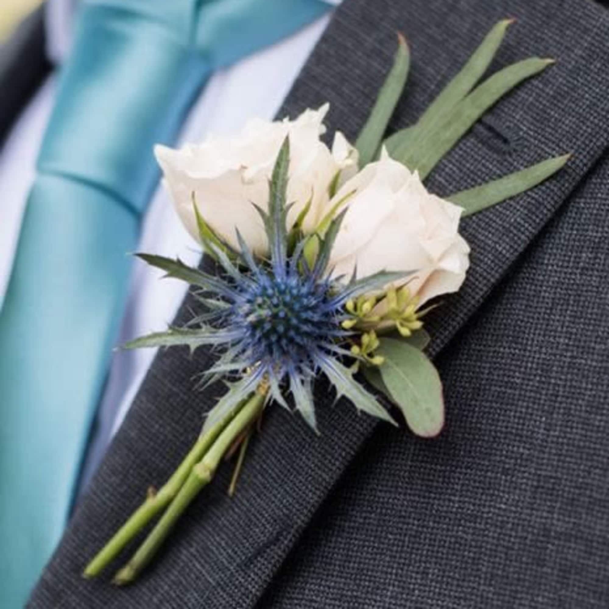 A classic red rose boutonni&egrave;re that compliments any suit. Perfect for prom