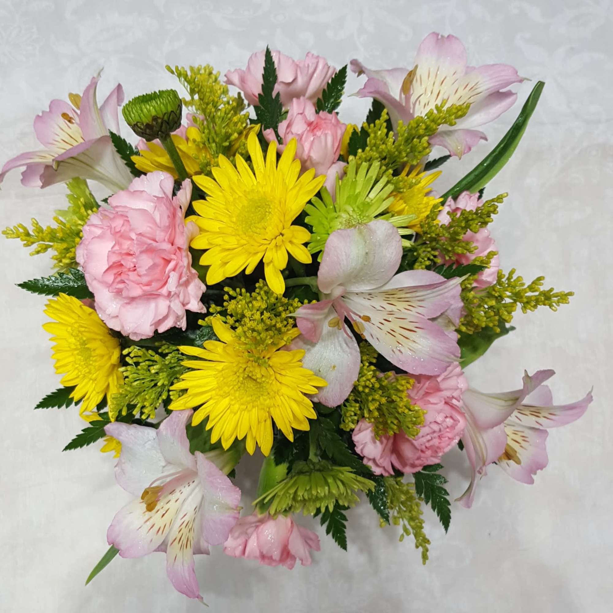Bouquet of pink and yellow flowers with alstroemeria and daisies