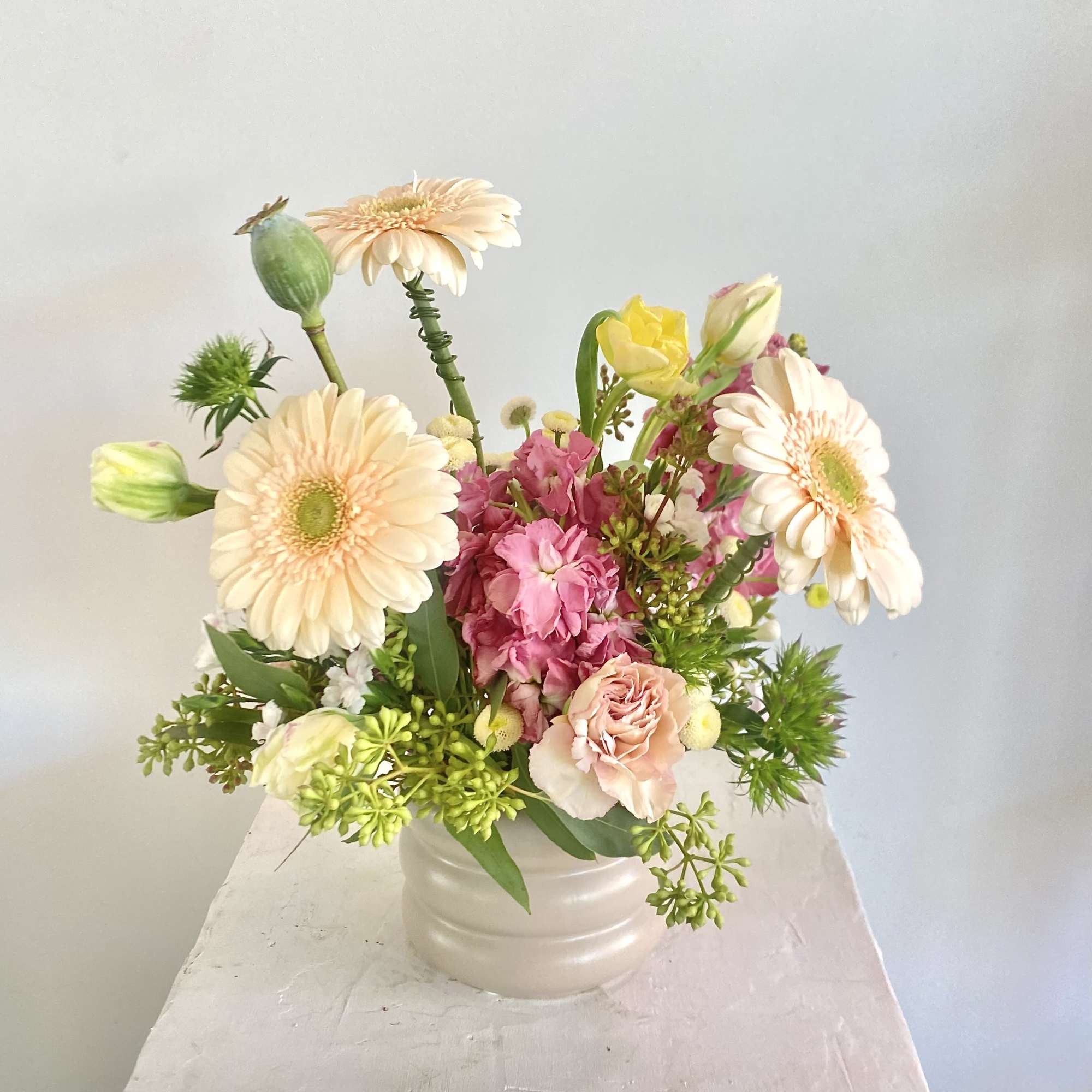 Enjoy a sophisticated arrangement in dreamy shades of mauve, taupe, and peach