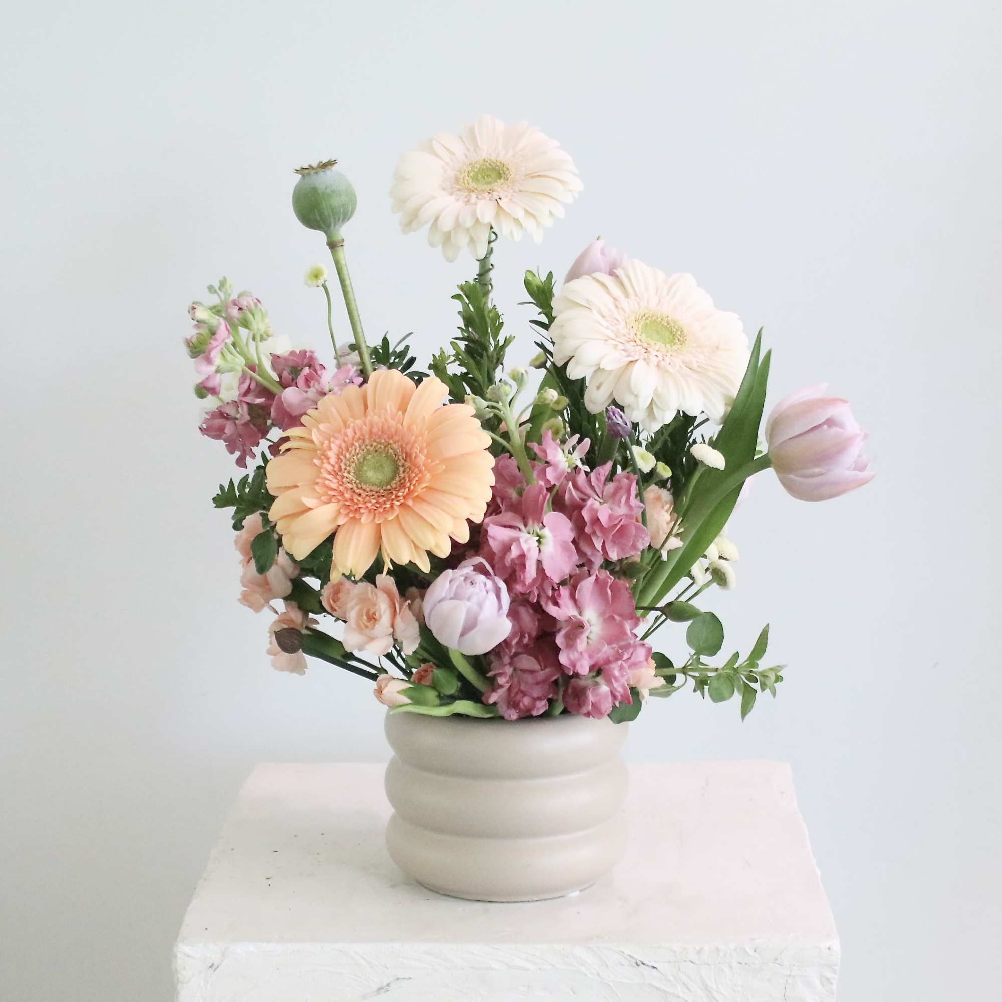 Enjoy a sophisticated arrangement in dreamy shades of mauve, taupe, and peach