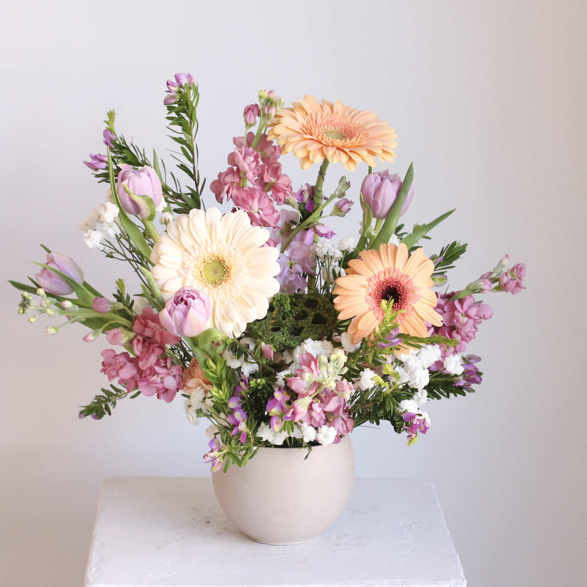 Enjoy a sophisticated arrangement in dreamy shades of mauve, taupe, and peach