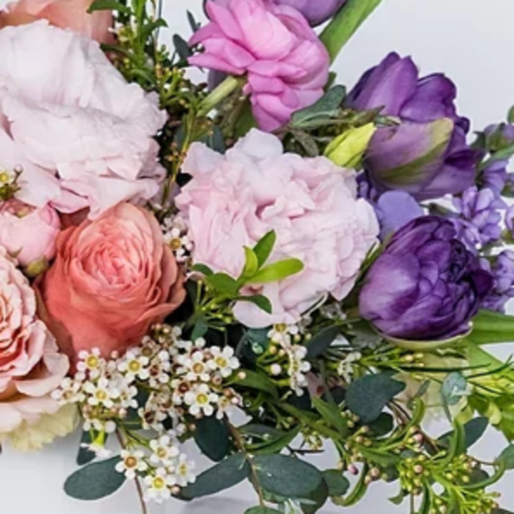 Bouquet of pink and purple flowers with small white filler blooms