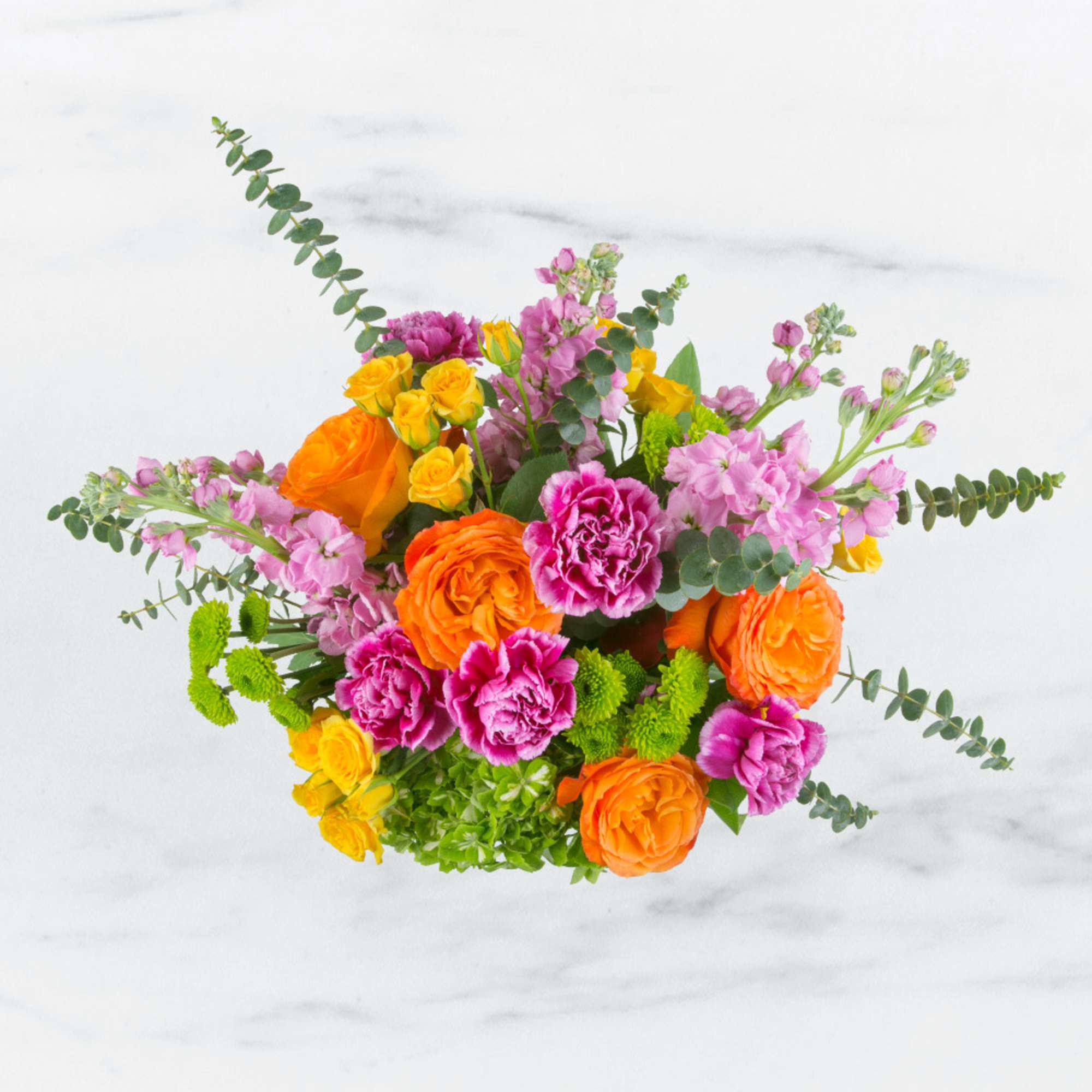 Bright mixed bouquet with orange and pink flowers and eucalyptus