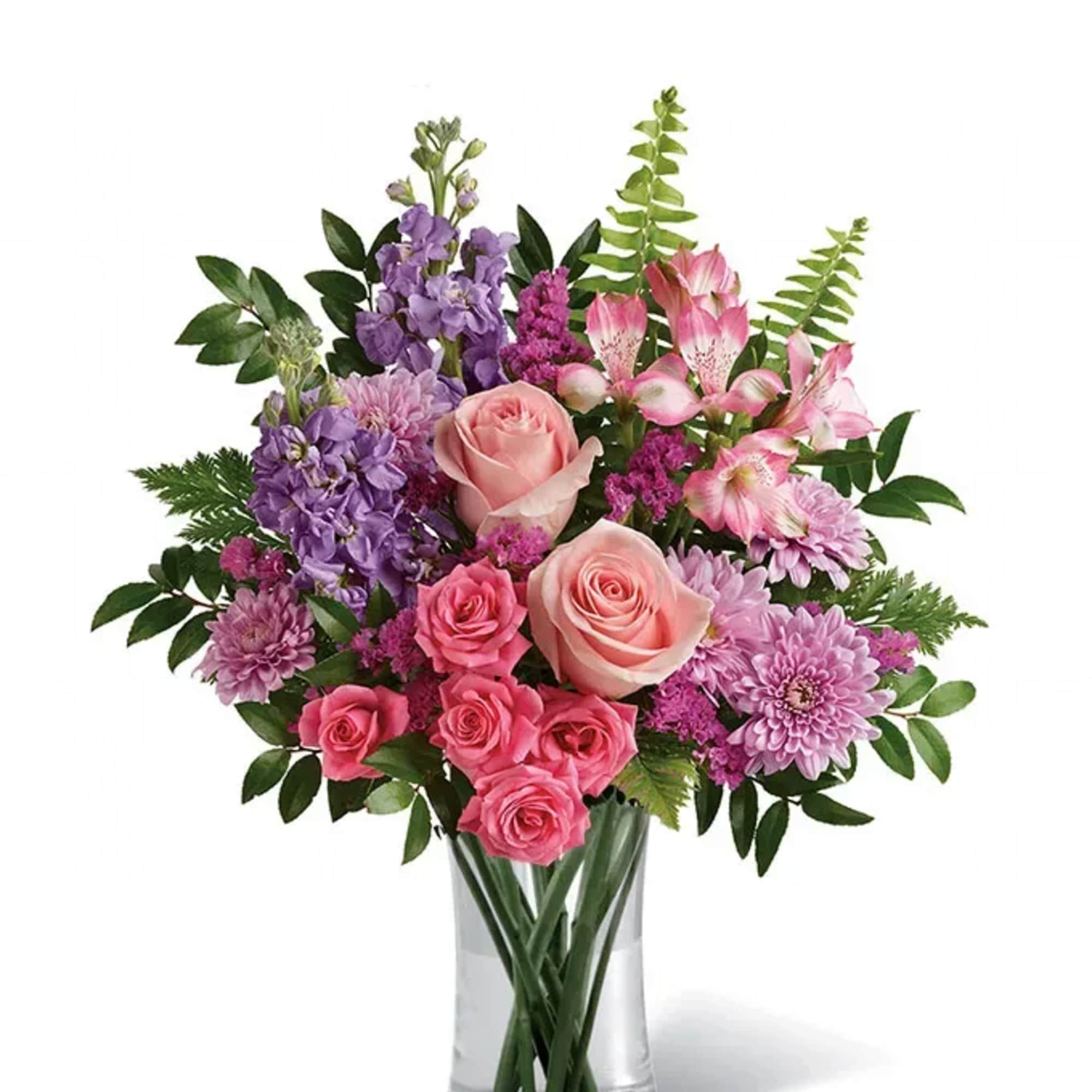 Pink and purple mixed bouquet in a clear glass vase