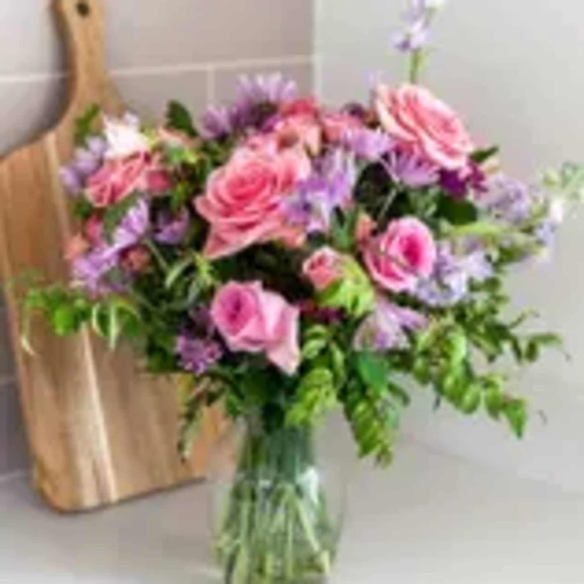 Pink and lavender mixed bouquet in a clear glass vase