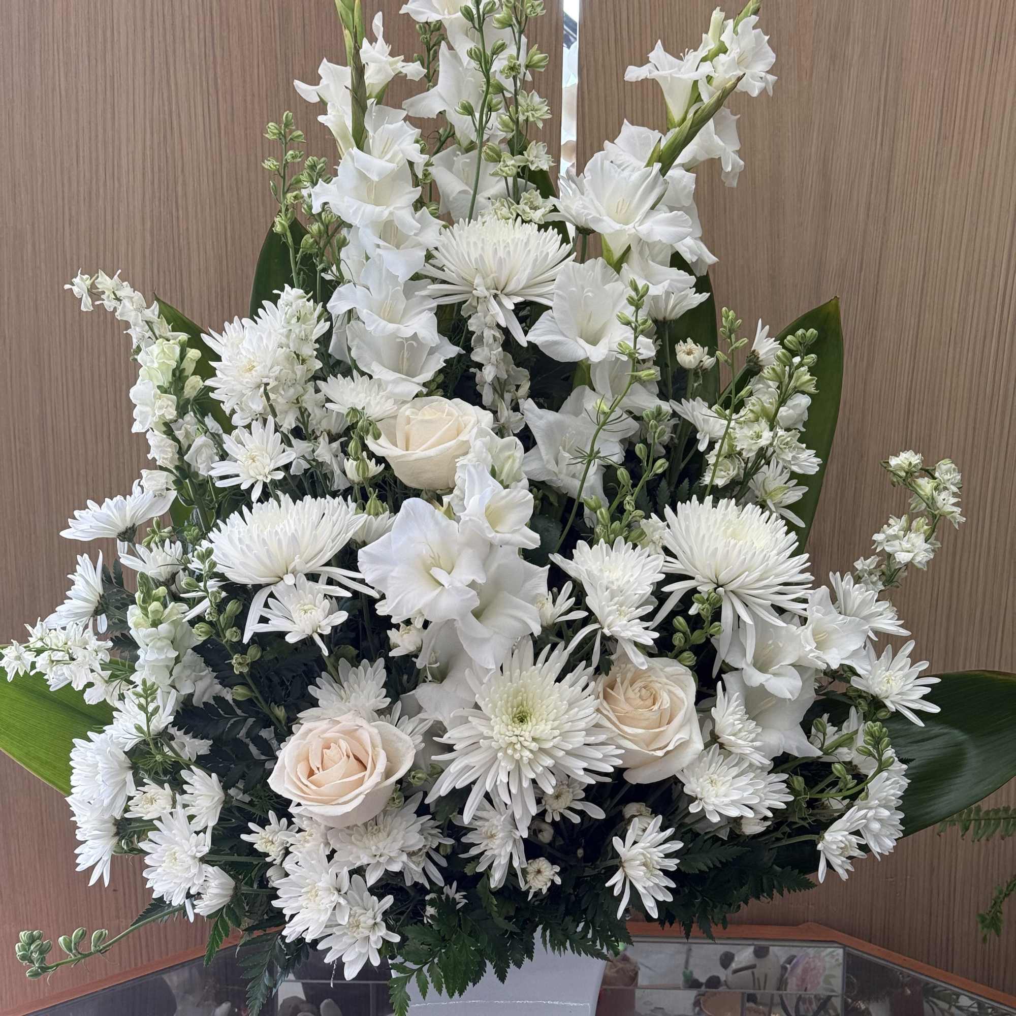 Mixed all white flower arrangement in a fancy box. 