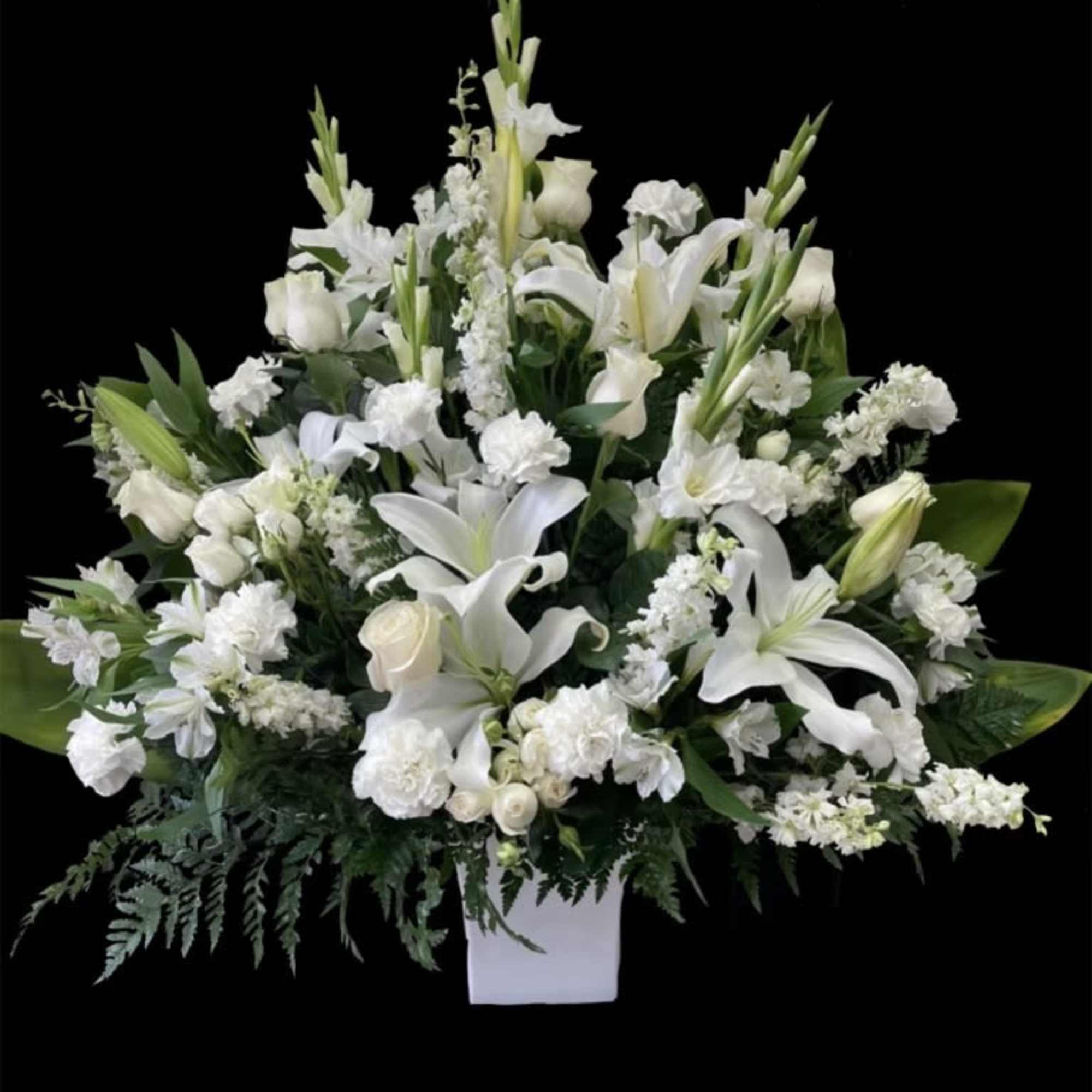 Mixed all white flower arrangement in a fancy box. 