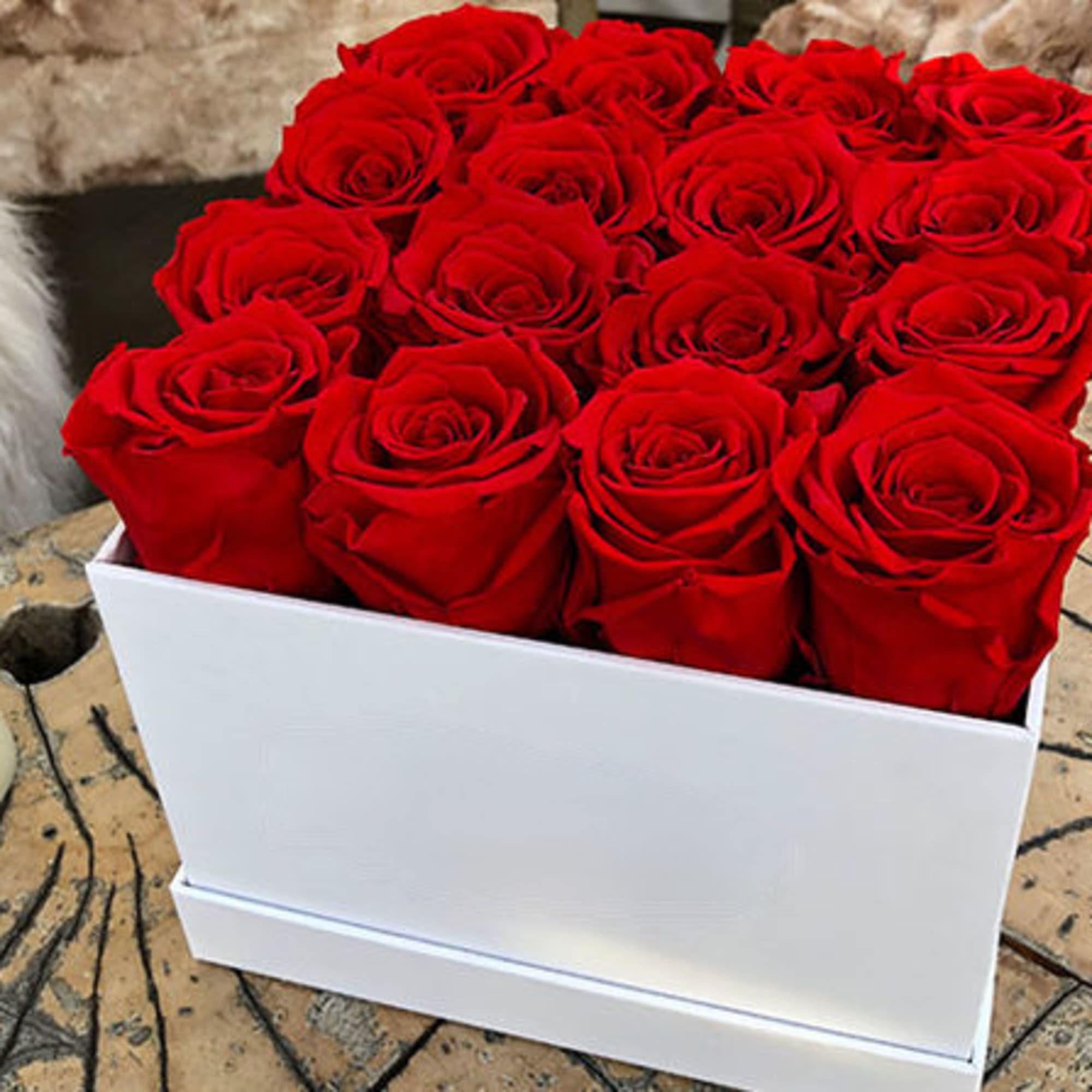 Red roses arranged in a white rectangular box