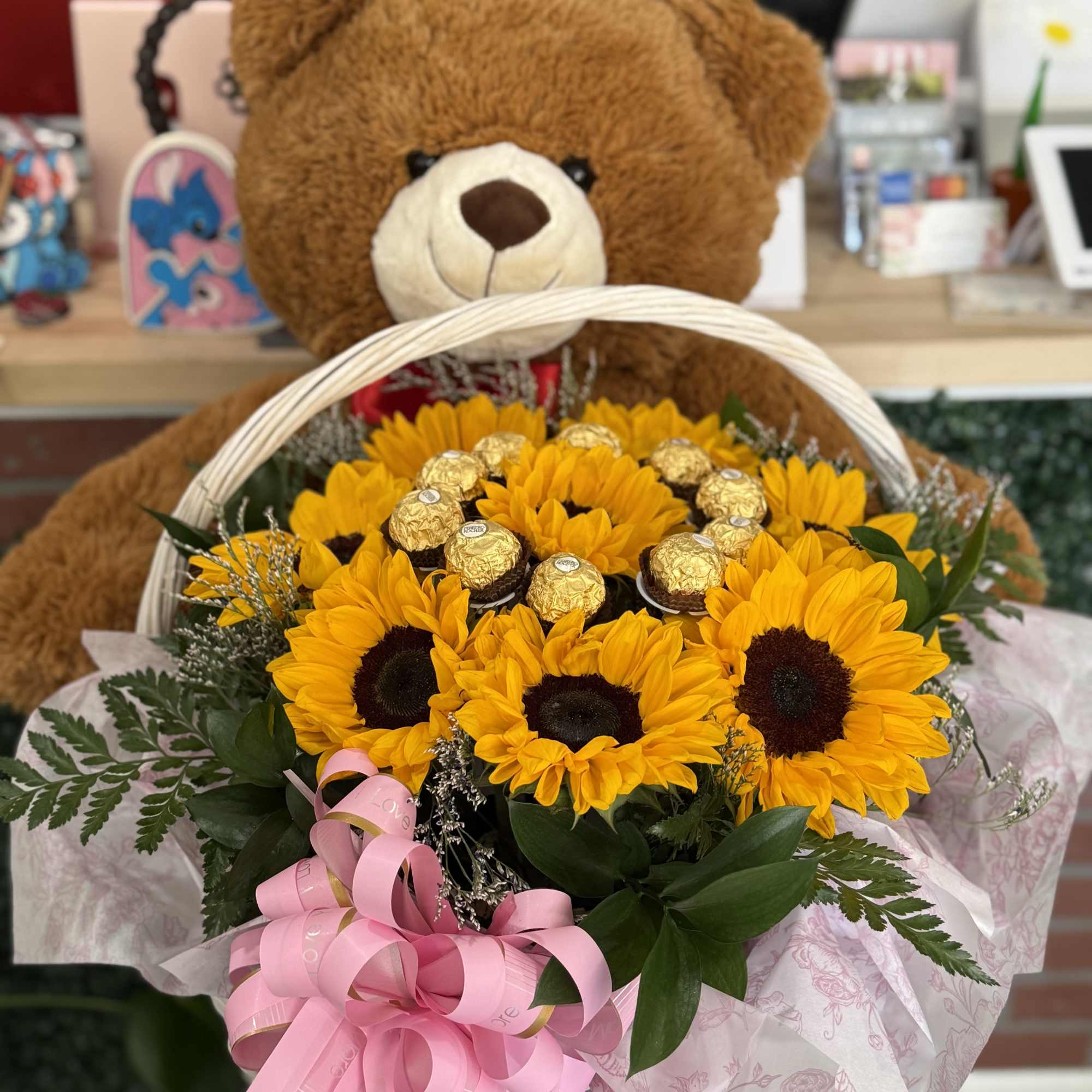 This love-filled basket pairs bright, happy sunflowers with chocolates, and an adorable