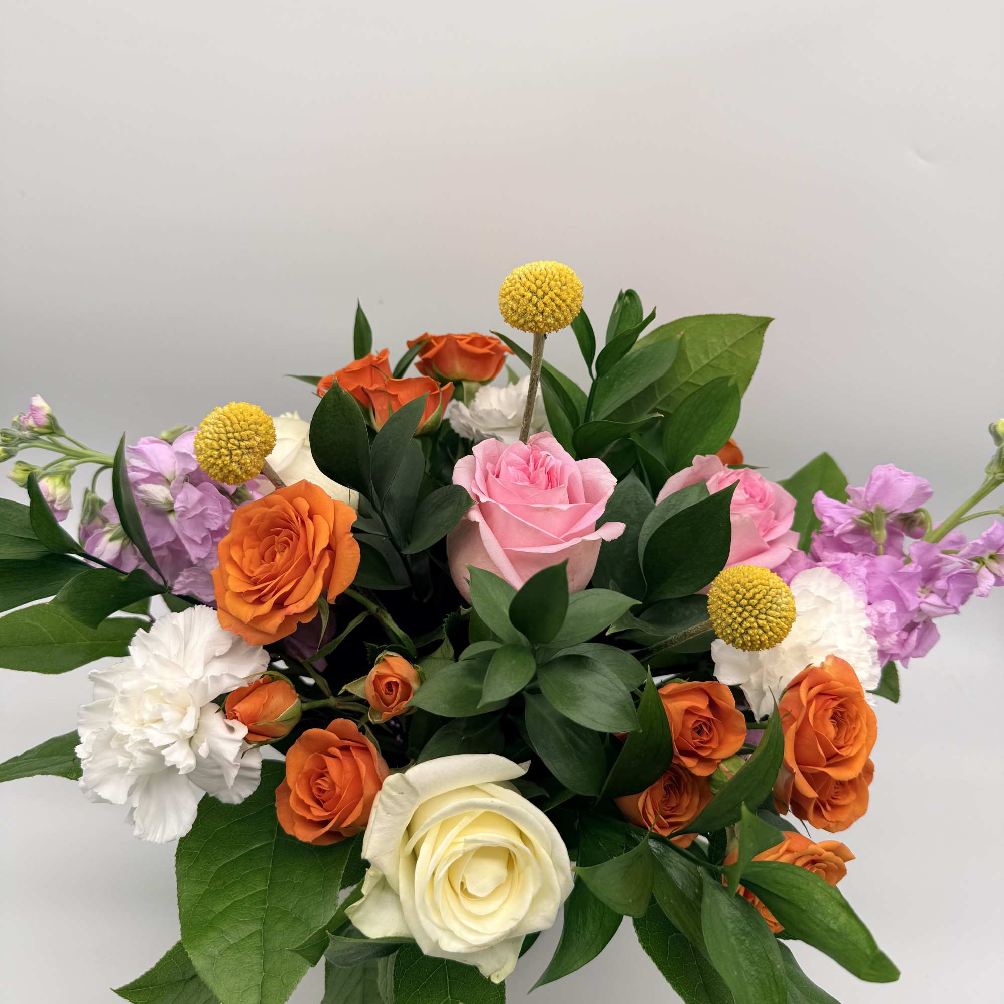 Soft, and playfully vibrant, this delightful arrangement is designed in a textured