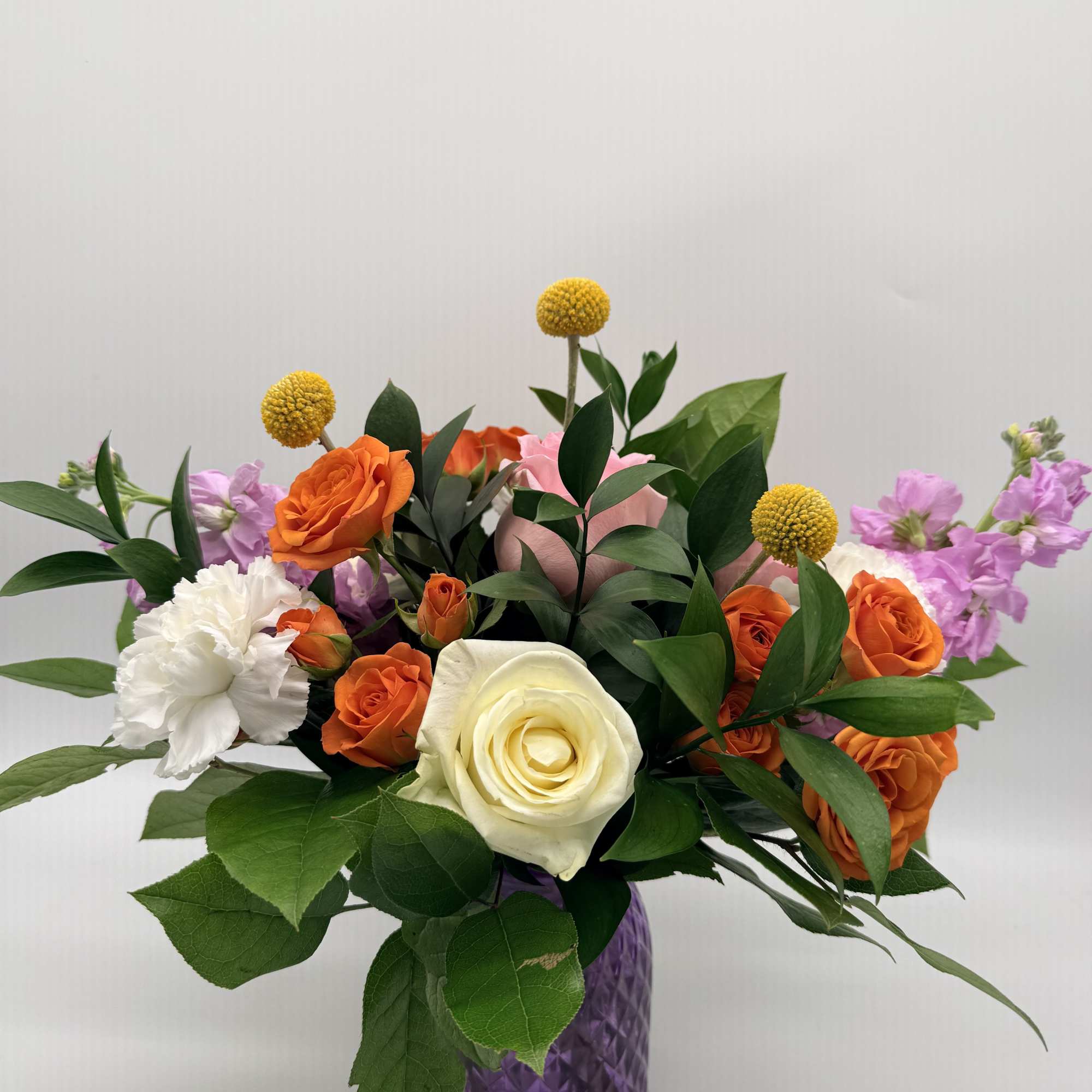 Soft, and playfully vibrant, this delightful arrangement is designed in a textured